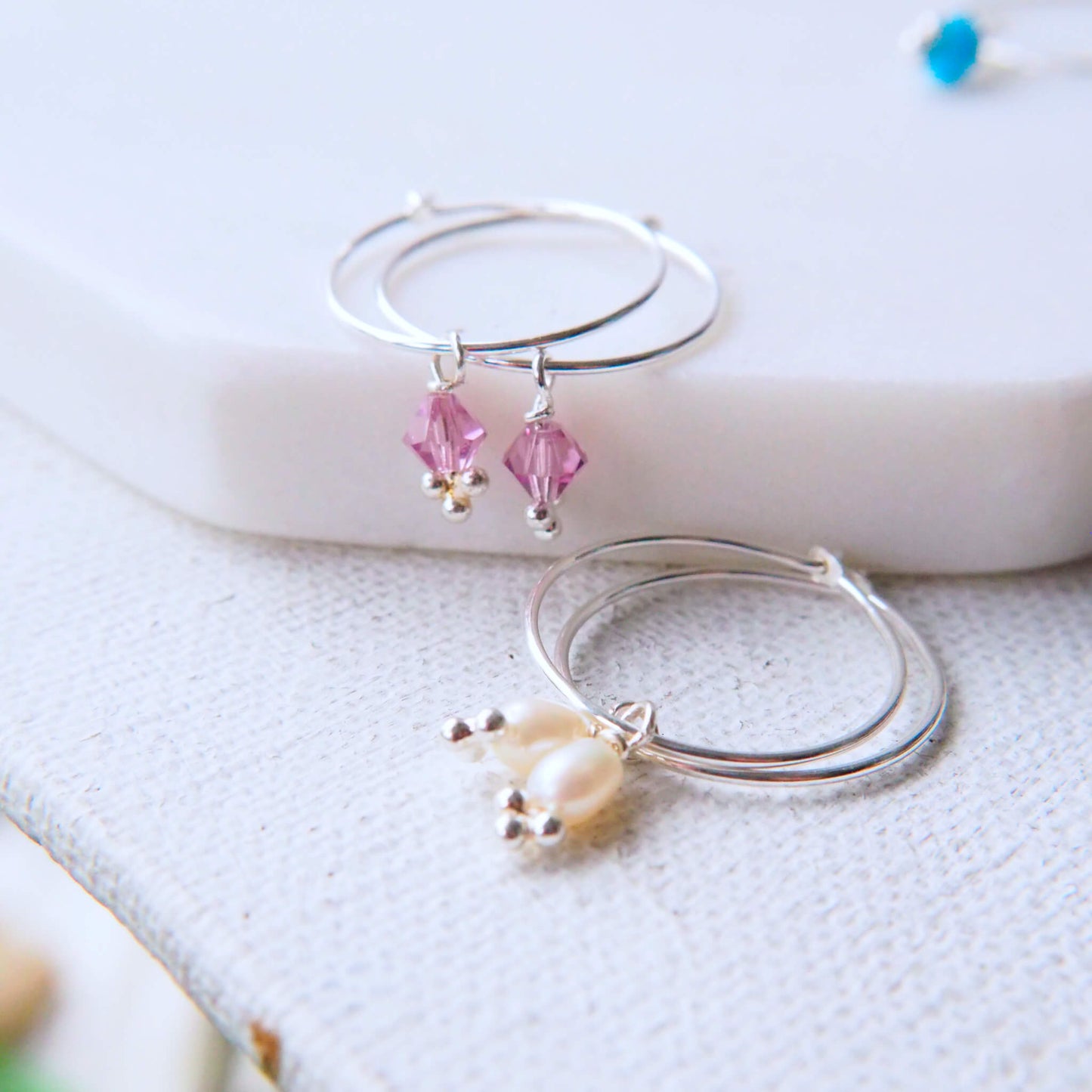 Pearl and Alexandrite birthstone Hoops for June. Small dusky pink crystal and freshwater pearl charm drops on a thin sterling silver wire hoop. Handmade in Scotland by maram jewellery.