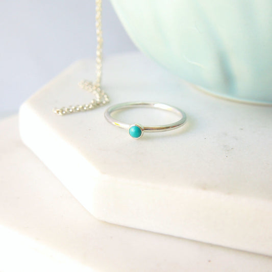 Turquoise and Sterling Silver Ring made from a small 3mm round turquoise gemstone set simply onto a modern band of round wire. Handmade to your ring size by maram jewellery in Scotland