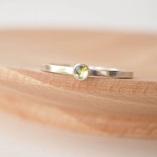 Small Peridot gemstone ring in sterling silver with a modern square band with a 3mm sized round moss green Peridot. Handmade in Edinburgh by Maram Jewellery