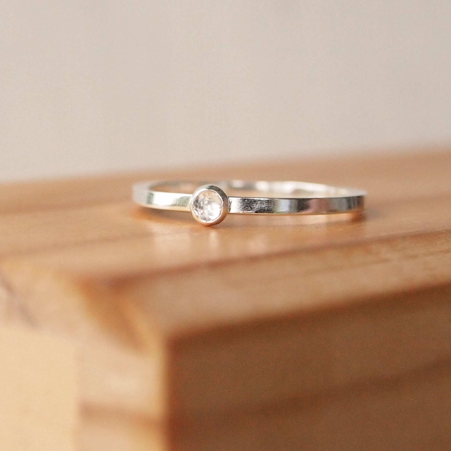 Simple Clear gemstone sparkly gemstone ring in sterling silver with a modern square band with a 3mm sized round White topaz faceted Cabochon. Handmade in Edinburgh by Maram Jewellery