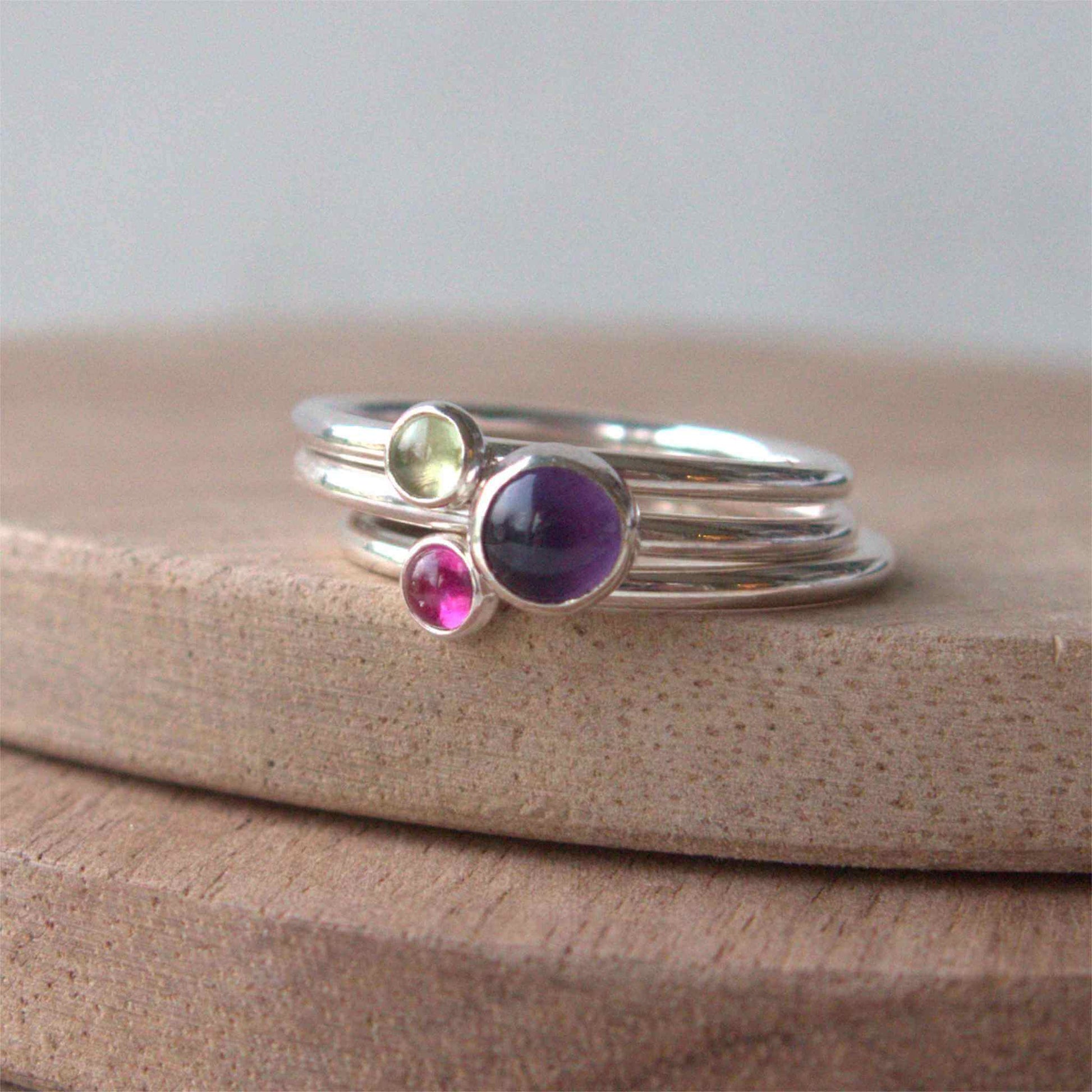 Three Birthstone Ring set made from Sterling Silver, each with a different birthstone in 5mm and 3mm size. This set has a large 5mm round Amethyst with a smaller 3mm Lab Opal and Peridot. Birthstones for August, February and July. Handmade in Scotland by Maram Jewellery