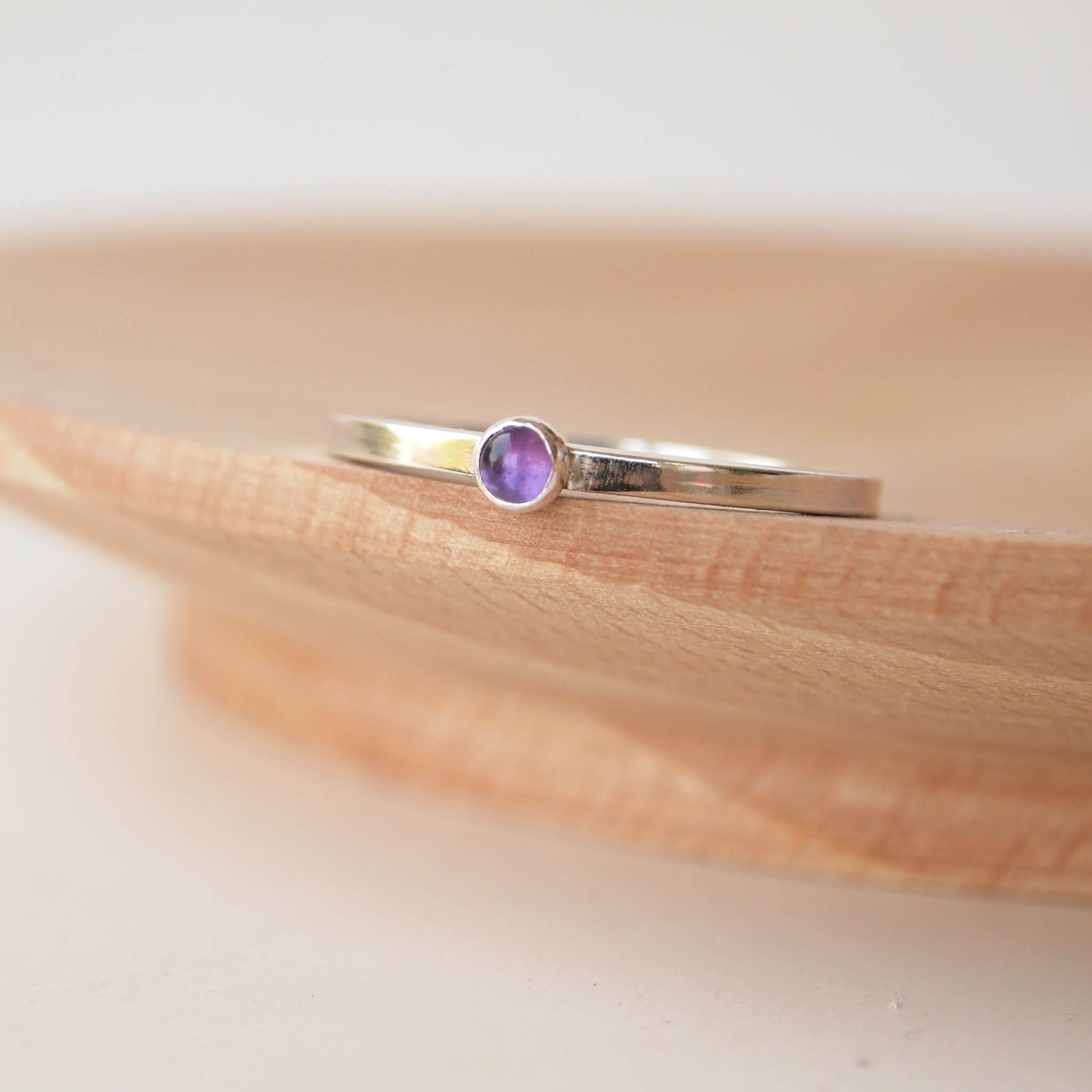 Amethyst and Sterling Silver Ring made from a small 3mm round deep purple Amethyst gemstone set simply onto a modern band of square wire. Handmade to your ring size by maram jewellery in Scotland