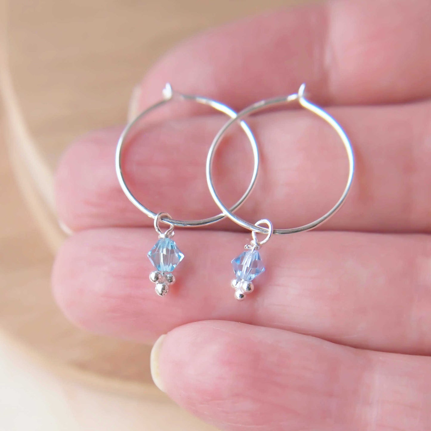 Silver hoops with crystal in aquamarine  blue