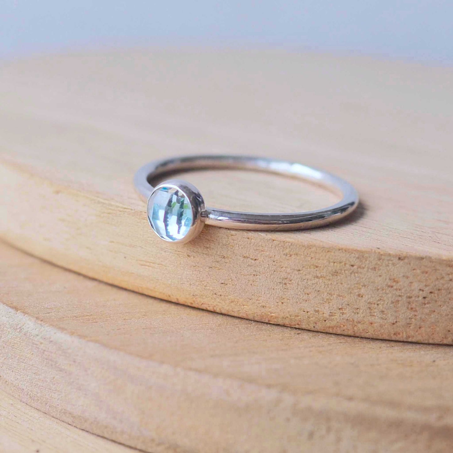 Blue Topaz and Sterling Silver March Birthstone Ring. A 5mm round pale blue Topaz cabochon set very simply onto a round band of sterling silver. handmade by maram jewellery in Scotland
