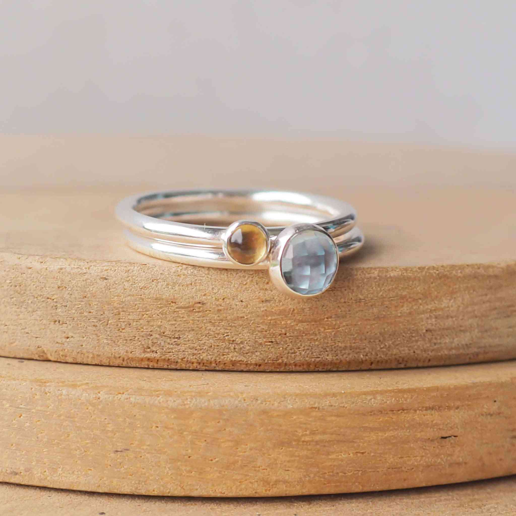 Two Birthstone Ring set with Blue Topaz and Citrine to mark March and November Birthdays. The two rings are made with Sterling Silver and a 5mm blue round cabochon, with a further ring with 3mm round gem in a yellow Citrine . Handmade in Scotland by maram jewellery