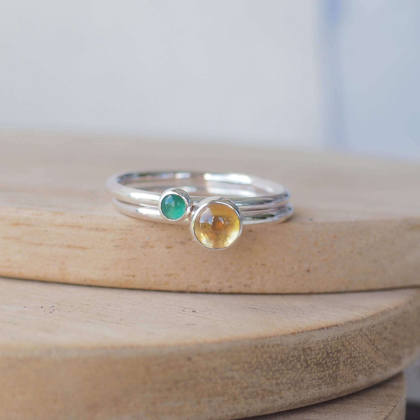 Citrine and Green Agate birthstone ring set. two simple silver rings, set with a round cabochon in green and yellow. Handmade by maram jewellery in Scotland
