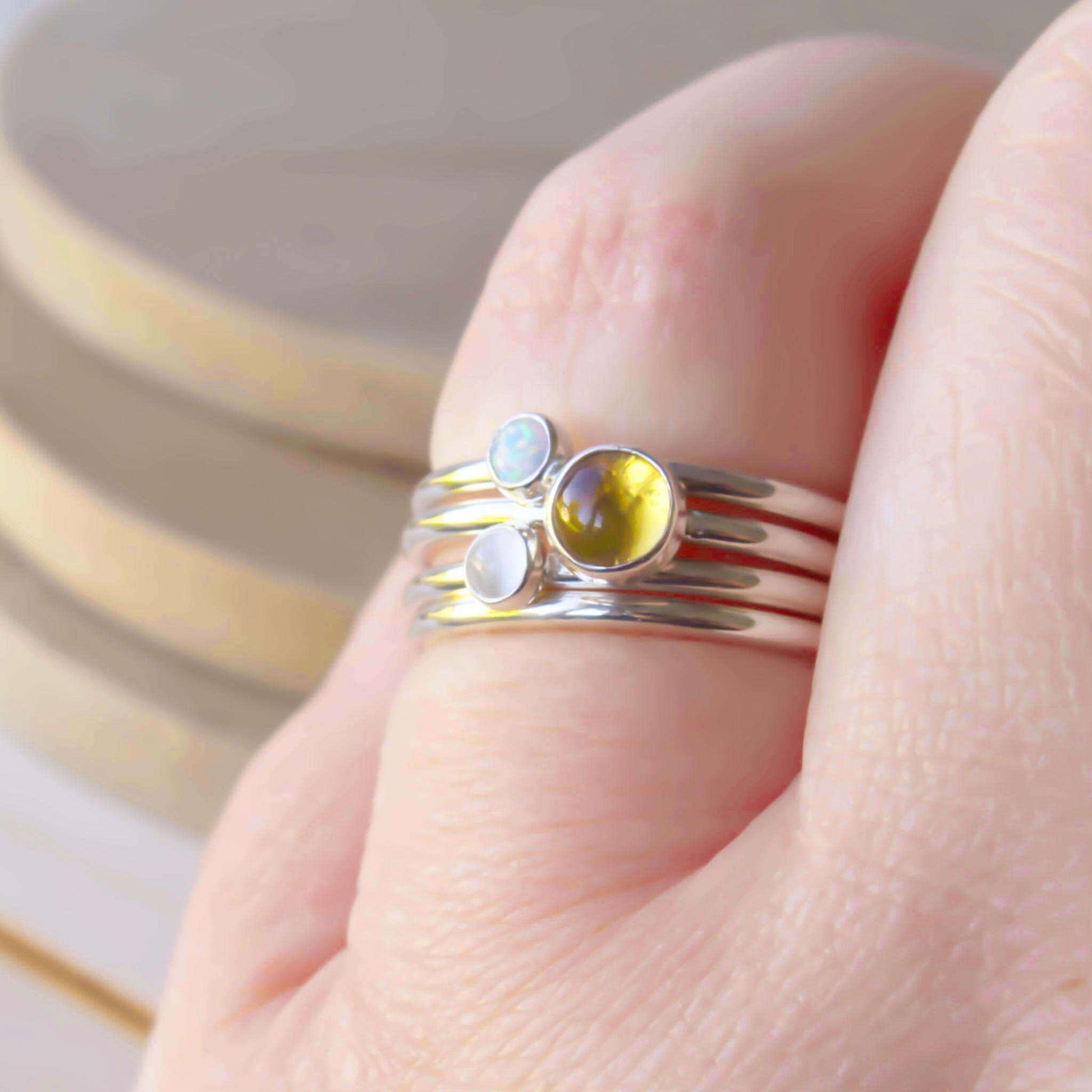 Three Birthstone Ring set made from Sterling Silver, each with a different birthstone in 5mm and 3mm size. This set has a large 5mm round Citrine with a smaller 3mm Lab Opal and Moonstone. Birthstones for November, June and October. Handmade in Scotland by Maram Jewellery.