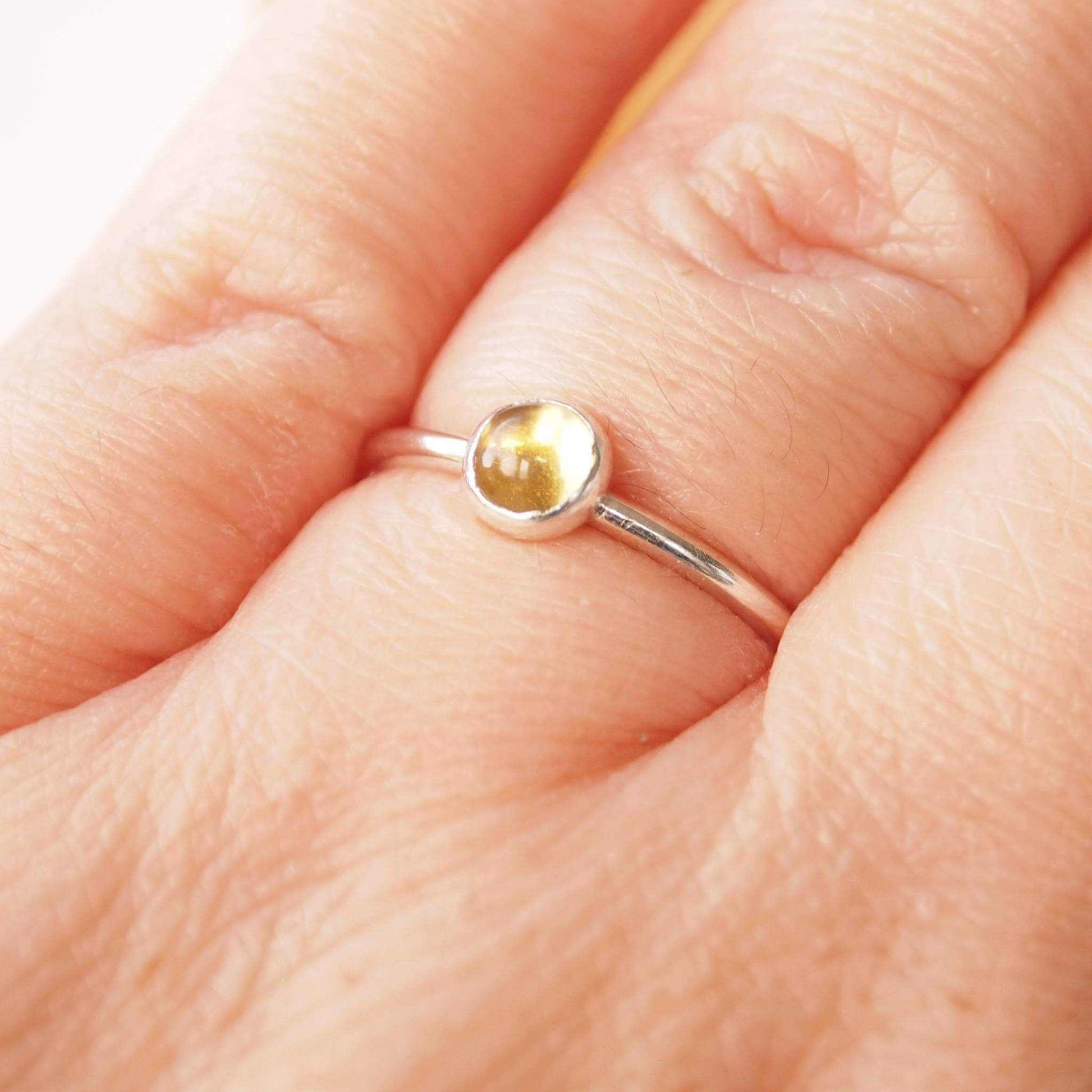 Citrine and Sterling Silver Ring made from a 5mm round warm yellow citrine gemstone set simply onto a modern band of round wire. Handmade to your ring size by maram jewellery in Scotland