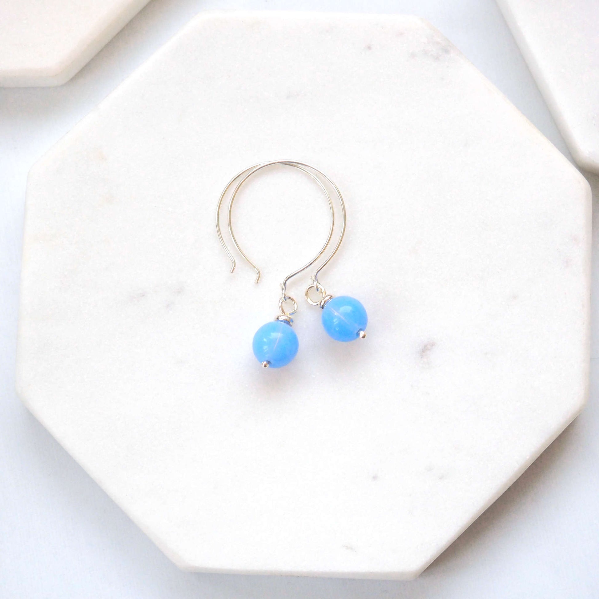 Pale baby blue Silver minimalist handmade silver hoops. Handcrafted ear wires with a round glass bead dropper. Made in Scotland by maram jewellery