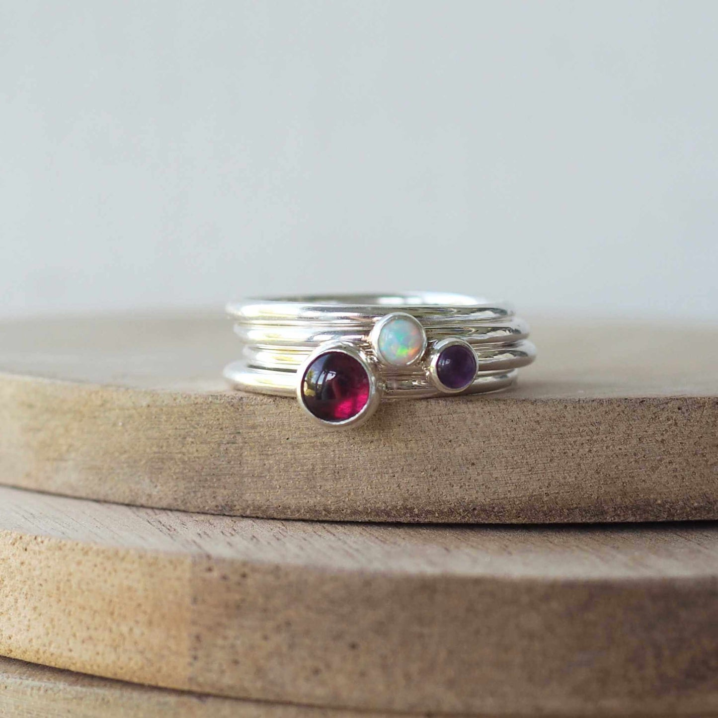 Garnet, Amethyst and Lab Opal Silver Triple Ring Set. Made from three rings in Sterling silver each with a different birthstone.Handmade in Scotland by maram jewellery