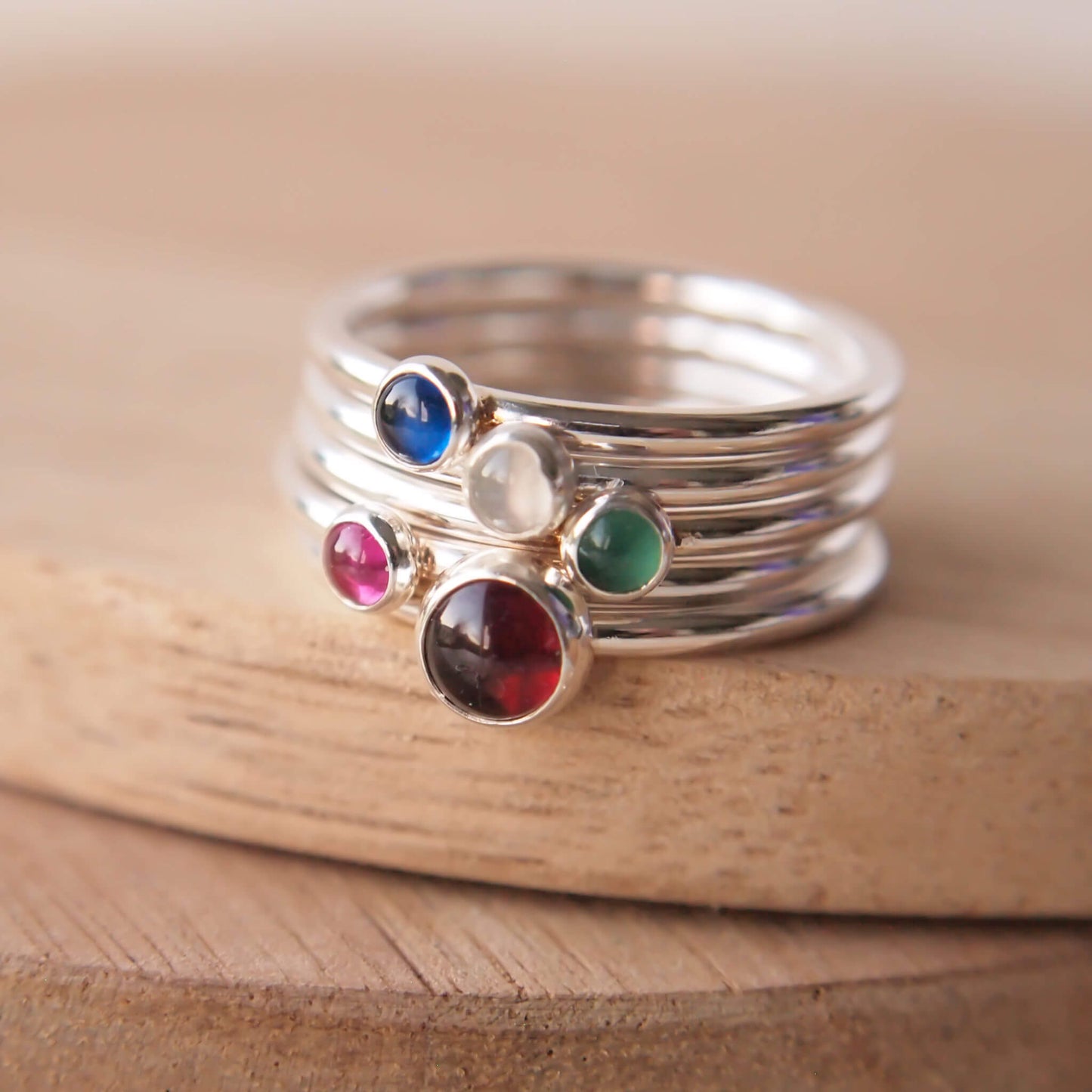 Family birthstone ring set with Garnet, Green agate, Lab Ruby, Lab Sapphire and Moonstone to mark January,May,June,July and September birthdays. Handmade by maram jewellery in Edinburgh