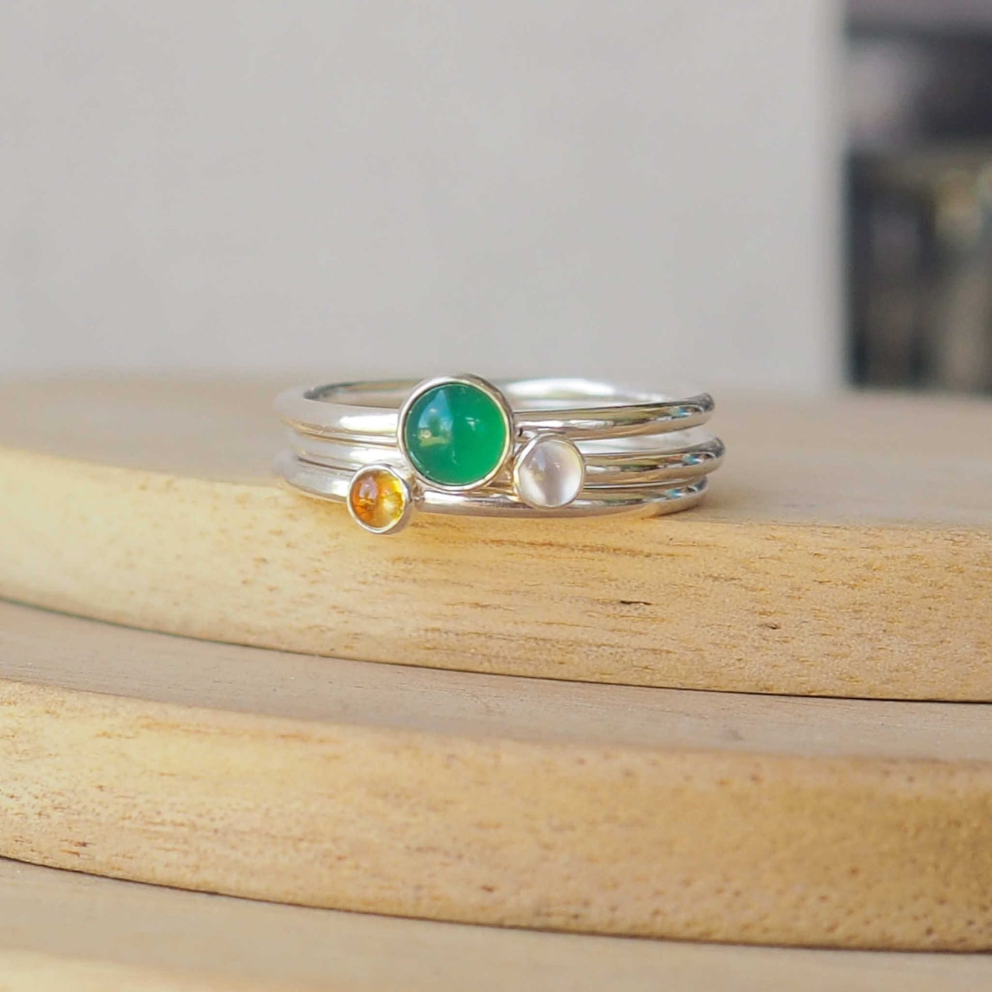 Three Birthstone Ring set made from Sterling Silver, with a 5mm round Green Agate Birthstone for May, and two smaller 3mm gemstones in Citrine for November, and Moonstone for June. The gemstones colours are emerald green, warm yellow and milky white. Handmade in Scotland by Maram Jewellery