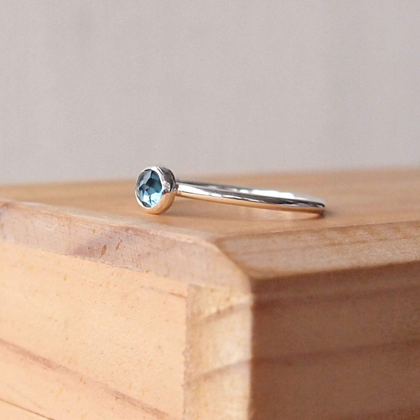 London Blue Topaz Sterling Silver Gemstone ring with a round 5mm facet cut teal Blue cabochon. Handmade in Scotland by maram jewellery