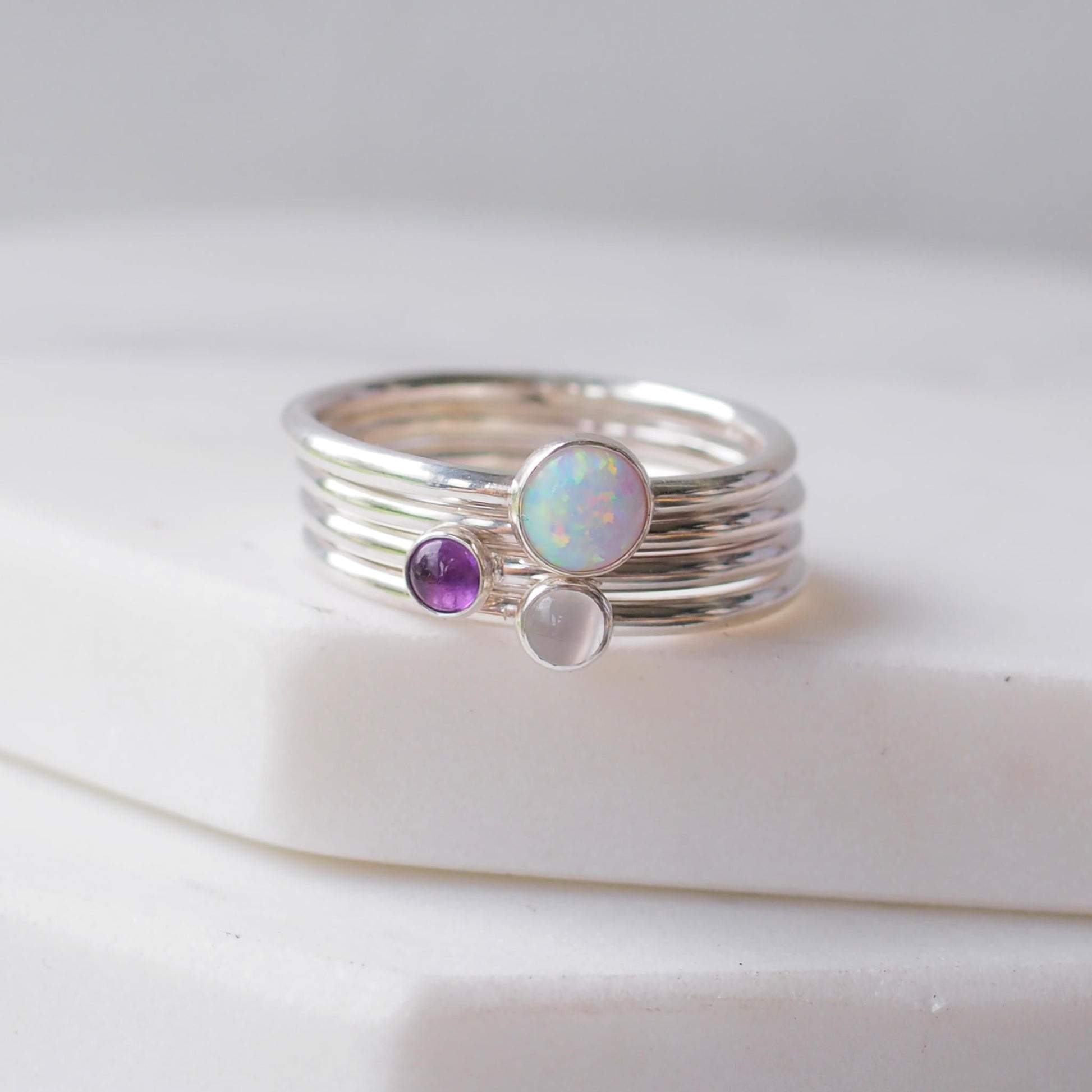 Three silver rings with lal Opal, Moonstone and Amethyst gemstones. Birthstones for February, June and October. Handmade to your ring size by maram jewellery in Scotland , UK