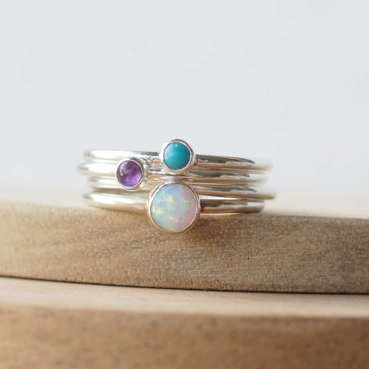 Three Birthstone Ring set made from Sterling Silver, each with a different birthstone in 5mm and 3mm size. This set has a large 5mm round Lab Opal with a smaller 3mm Amethyst and Turquoise. Birthstones for October, February and December. Handmade in Scotland by Maram Jewellery