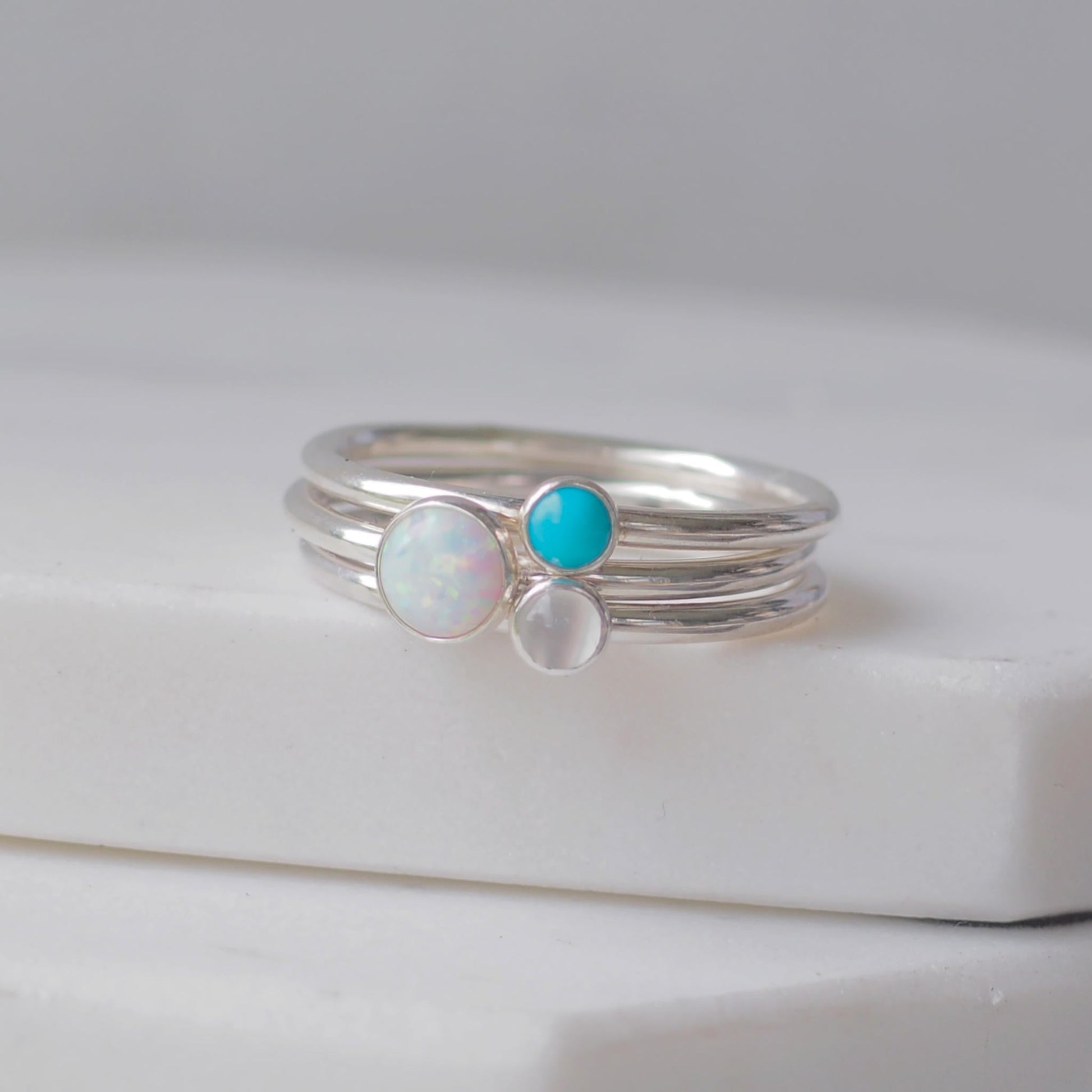 Three silver rings with lal Opal Turquoise and Moonstone gemstones. Birthstones for June, December and October. Handmade to your ring size by maram jewellery in Scotland , UK