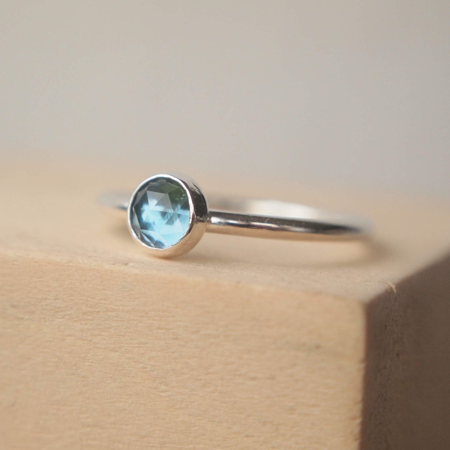 London Blue Topaz Sterling Silver Gemstone ring with a round 5mm facet cut teal Blue cabochon. Handmade in Scotland by maram jewellery