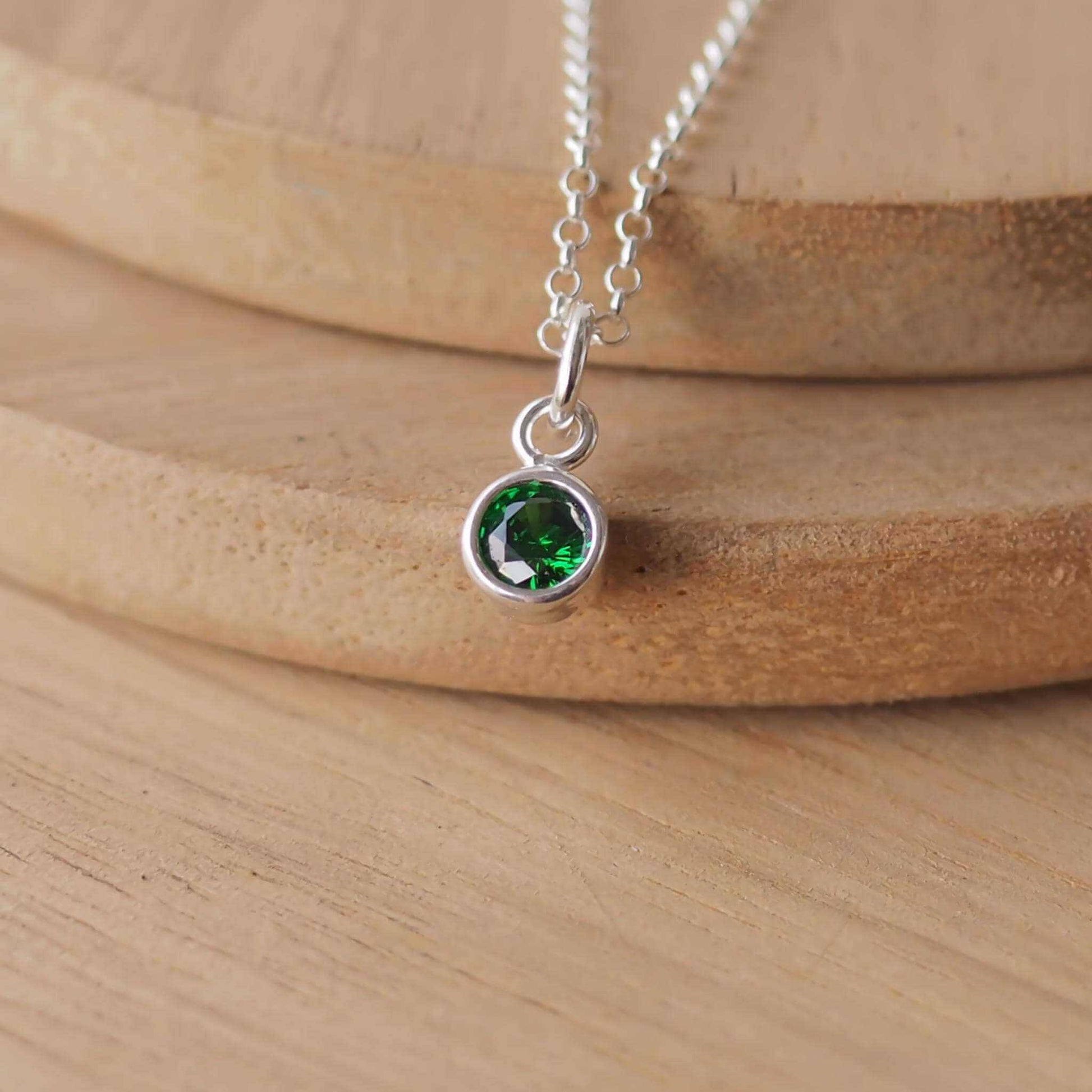 Small Sterling Silver and Cubic Zirconia Emerald Green necklace. A small 4mm faceted round rich green gemstone with a simple silver setting on a trace style chain, suitable as a May Birthstone charm . Handmade in Scotland by Maram Jewellery