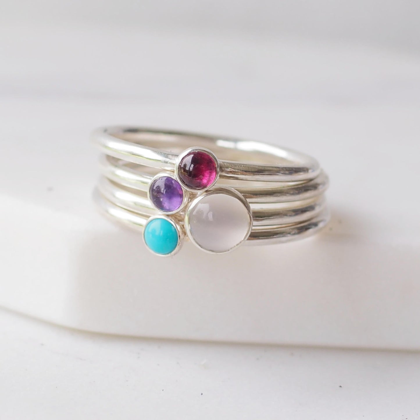 gemstone Birthstone rings in silver, moonstone, amethyst, Garnet and Turquoise to symbolise June, February, August and December Birthstones. Handmade in Scotland UK by Maram Jewellery