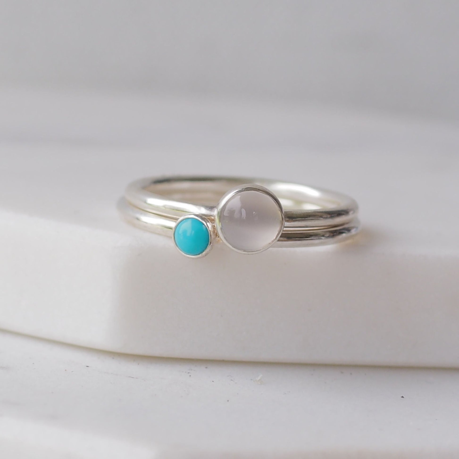 Two silver rings with moonstone and turquoise gemstones. Birthstones for June and December. Handmade to your ring size by maram jewellery in Scotland , UK