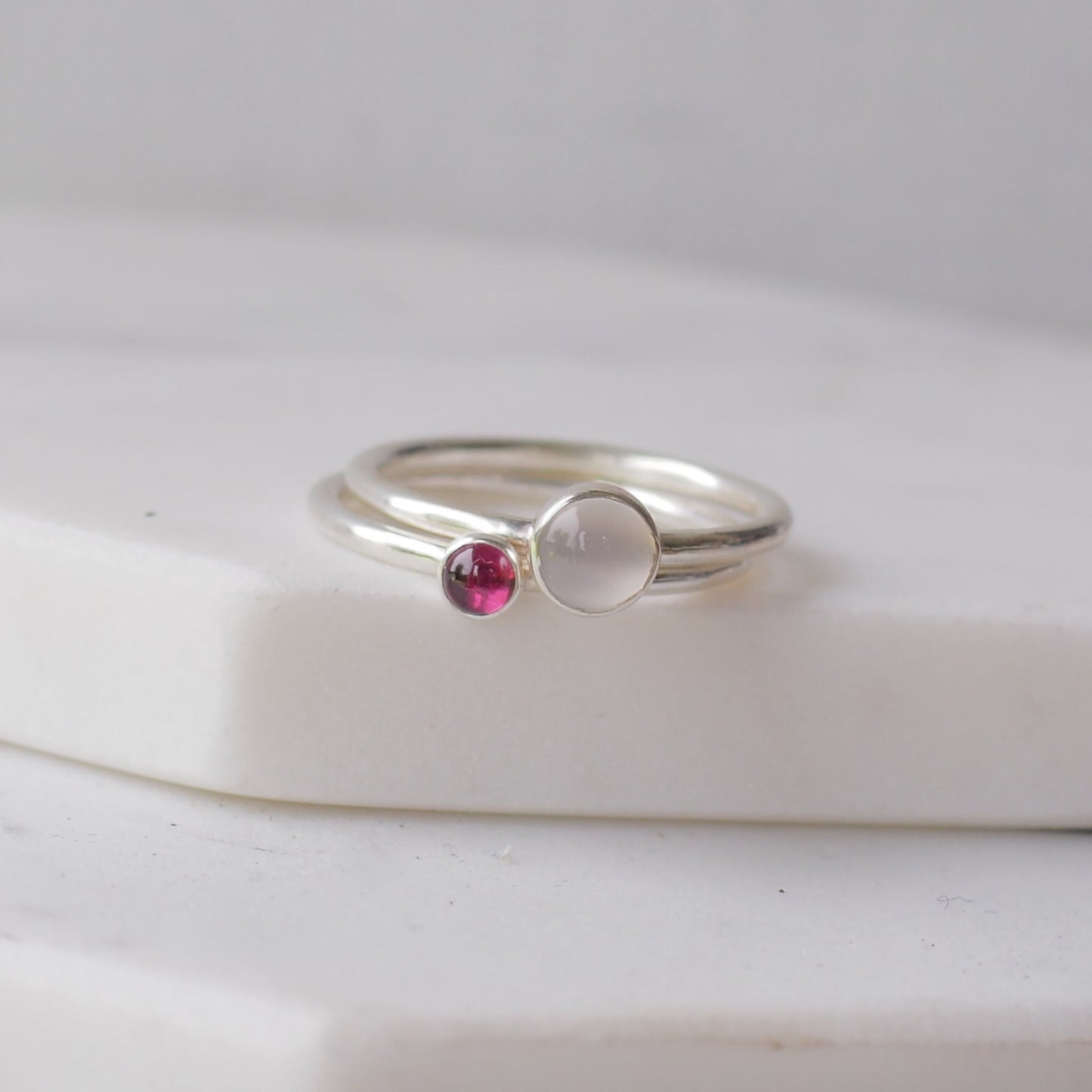 Two silver rings with moonstone and garnet gemstones. Birthstones for June and January. Handmade to your ring size by maram jewellery in Scotland , UK