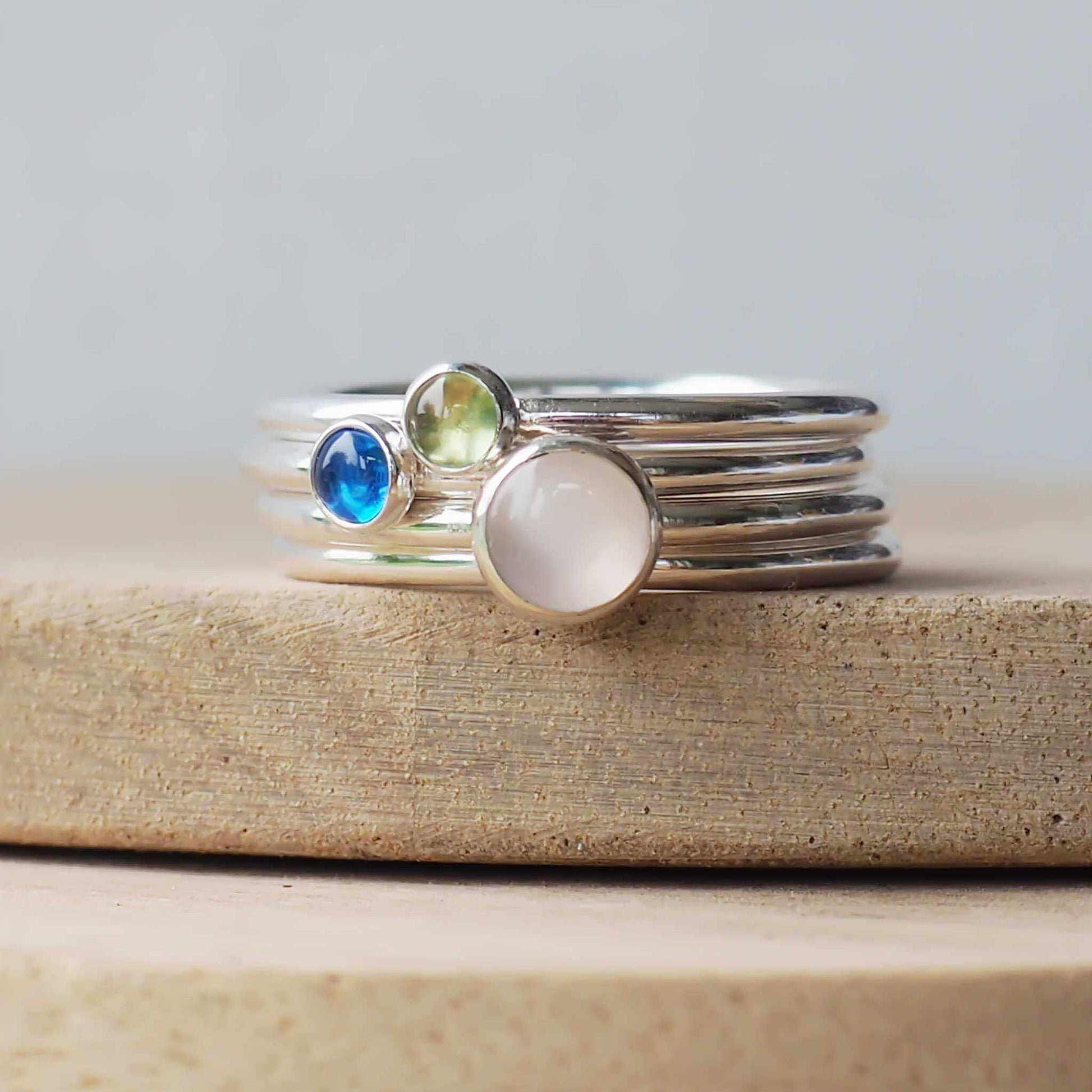 Three Birthstone Ring set made from Sterling Silver, each with a different birthstone in 5mm and 3mm size. This set has a large 5mm round Moonstone with a smaller 3mm Lab Sapphire and Peridot. Birthstones for June, September and August. Handmade in Scotland by Maram Jewellery.