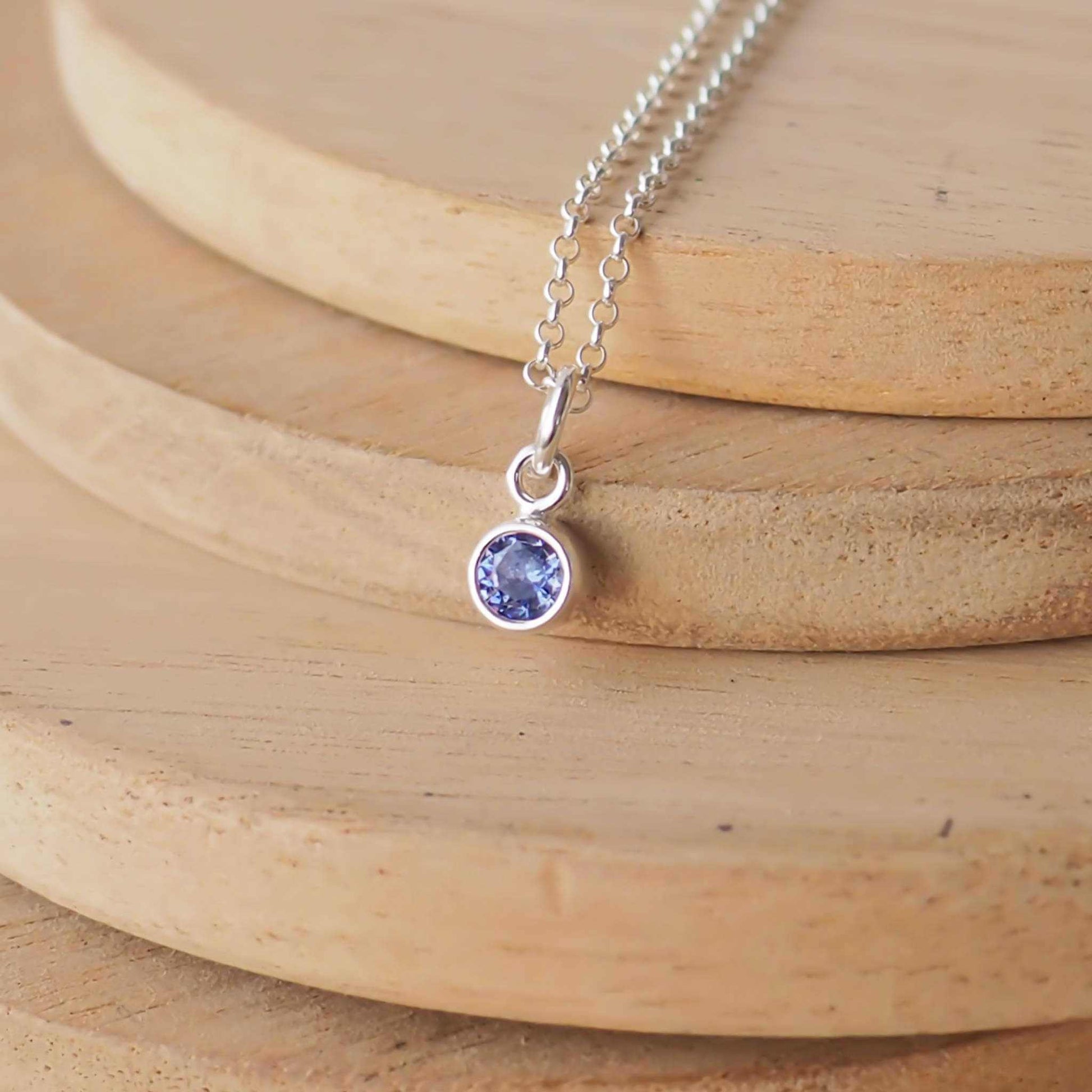 Small Sterling Silver and Cubic Zirconia Sapphire Blue necklace. A small 4mm faceted round blue gemstone with a simple silver setting on a trace style chain, suitable as a September Birthstone charm . Handmade in Scotland by Maram Jewellery