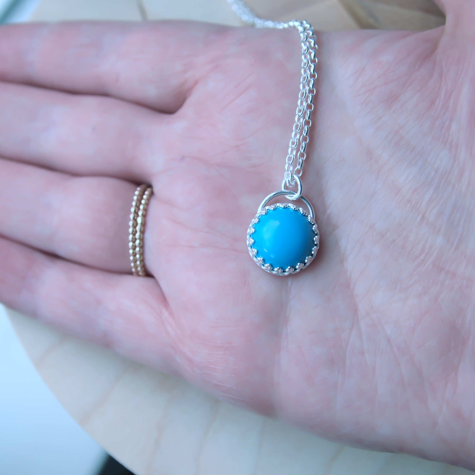 Handmade Turquoise Necklace with a round stone and a simple silver setting. December Birthstone is Turquoise, making this a perfect December Birthday Gift. Handmade by a small indie business  jeweller in Edinburgh UK