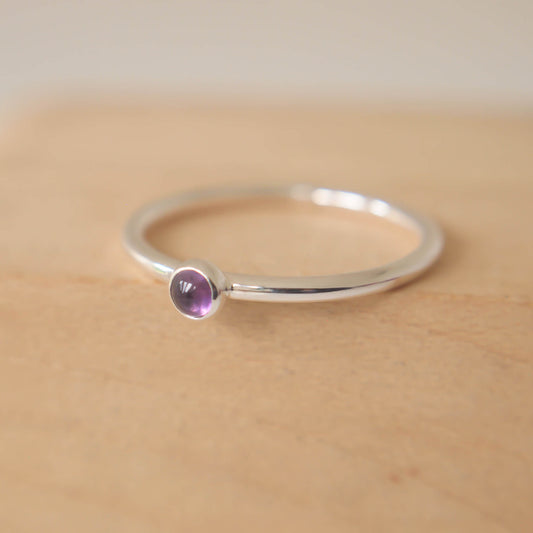 Amethyst and Sterling Silver Ring made from a small 3mm round deep purple Amethyst gemstone set simply onto a modern band of fully round wire. Handmade to your ring size by maram jewellery in Scotland
