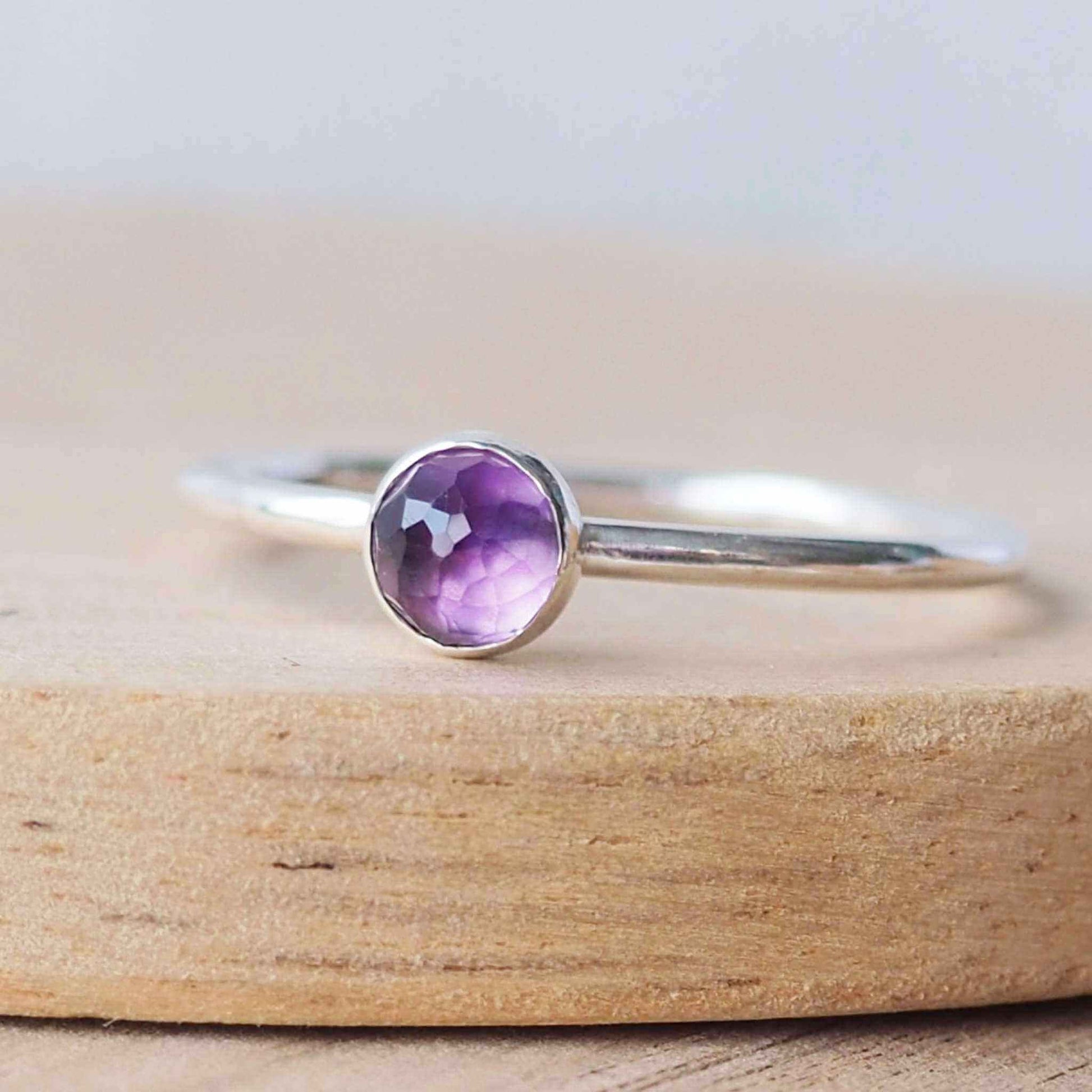 Purple amethyst and sterling silver ring made from a round band of silver with a 5mm round faceted cabochon. These are handmade to your size buy maram jewellery in Scotland