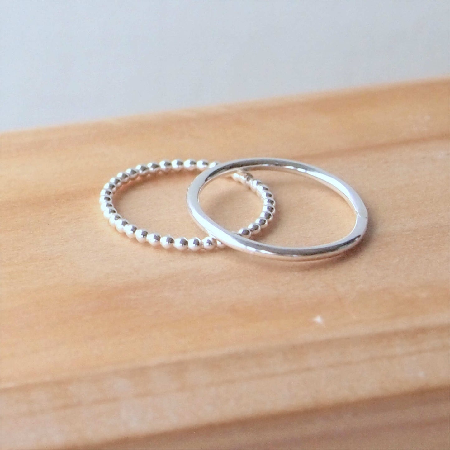 Double silver ring set with two textured band. One is a fully round halo style band and the second is a 'bubble' style ring that is made from tiny circles of sterling silver pearl wire in a row. The rings are Sterling Silver and Handmade in Scotland by maram jewellery