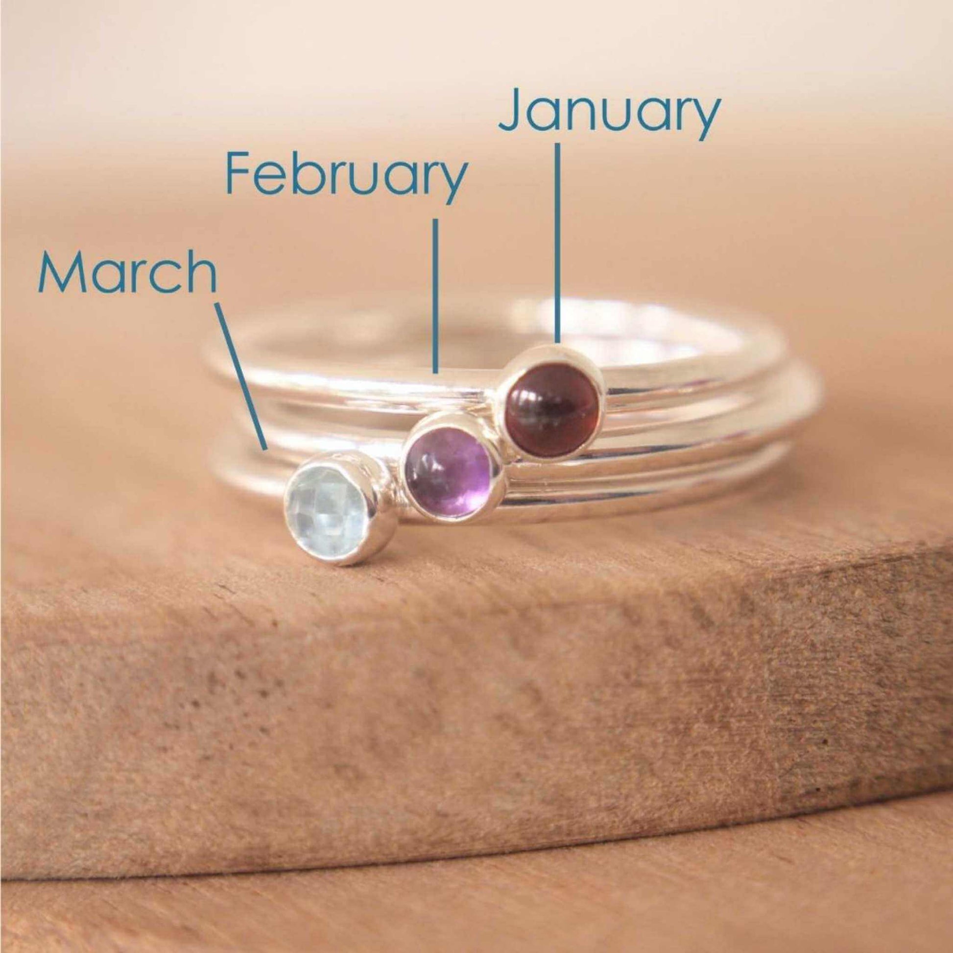 Three Silver rings, each set simply with a single gemstone in Garnet, Amethyst and Blue Topaz in a round 3mm size. Birthstones for January, February and March. Handmade in Scotland  by Maram Jewellery