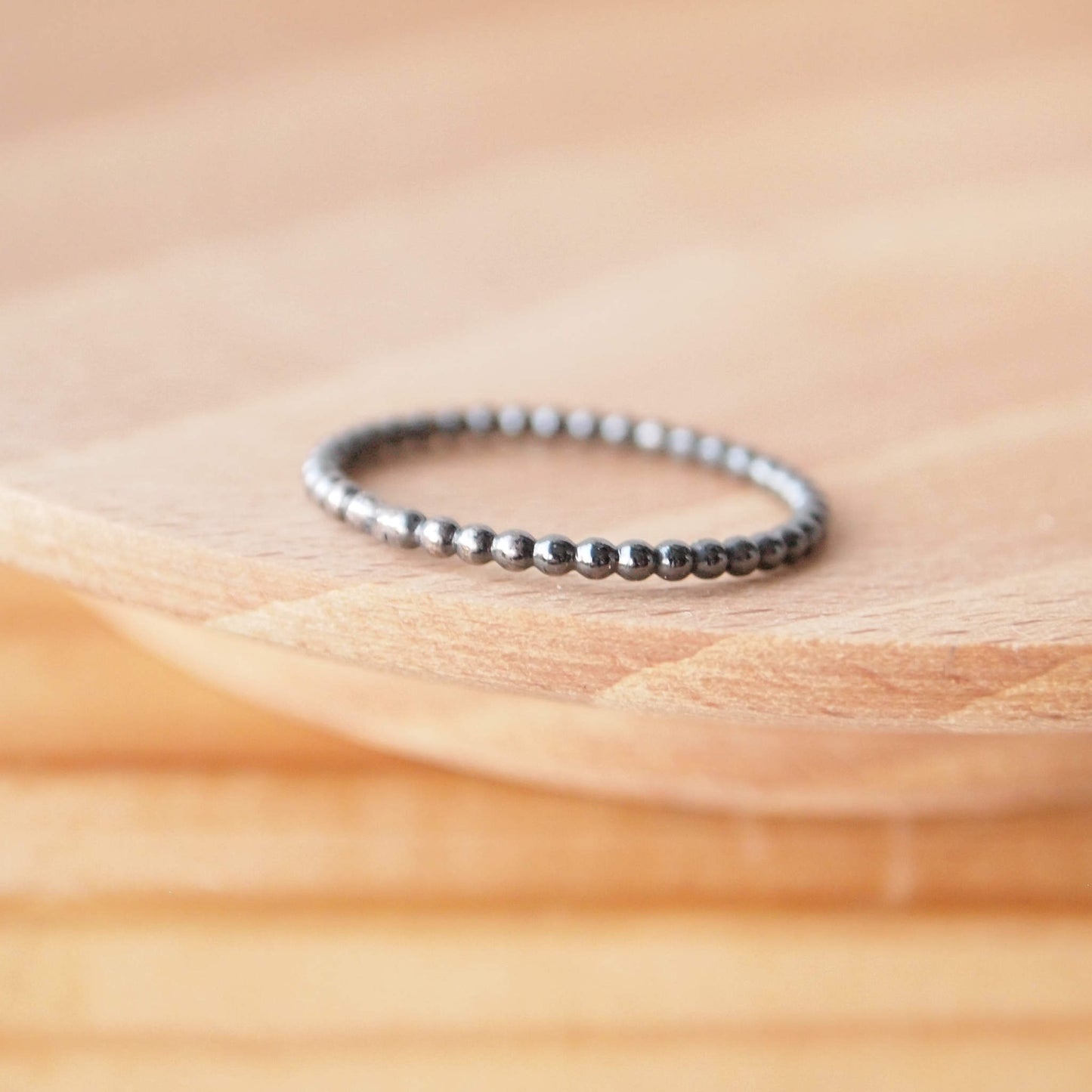 Black Silver ball bubble style ring. A simple band made from wire that looks like little round beads strung together. The ring is silver which has been oxidised to make it black. Handmade in Scotland by maram jewellery