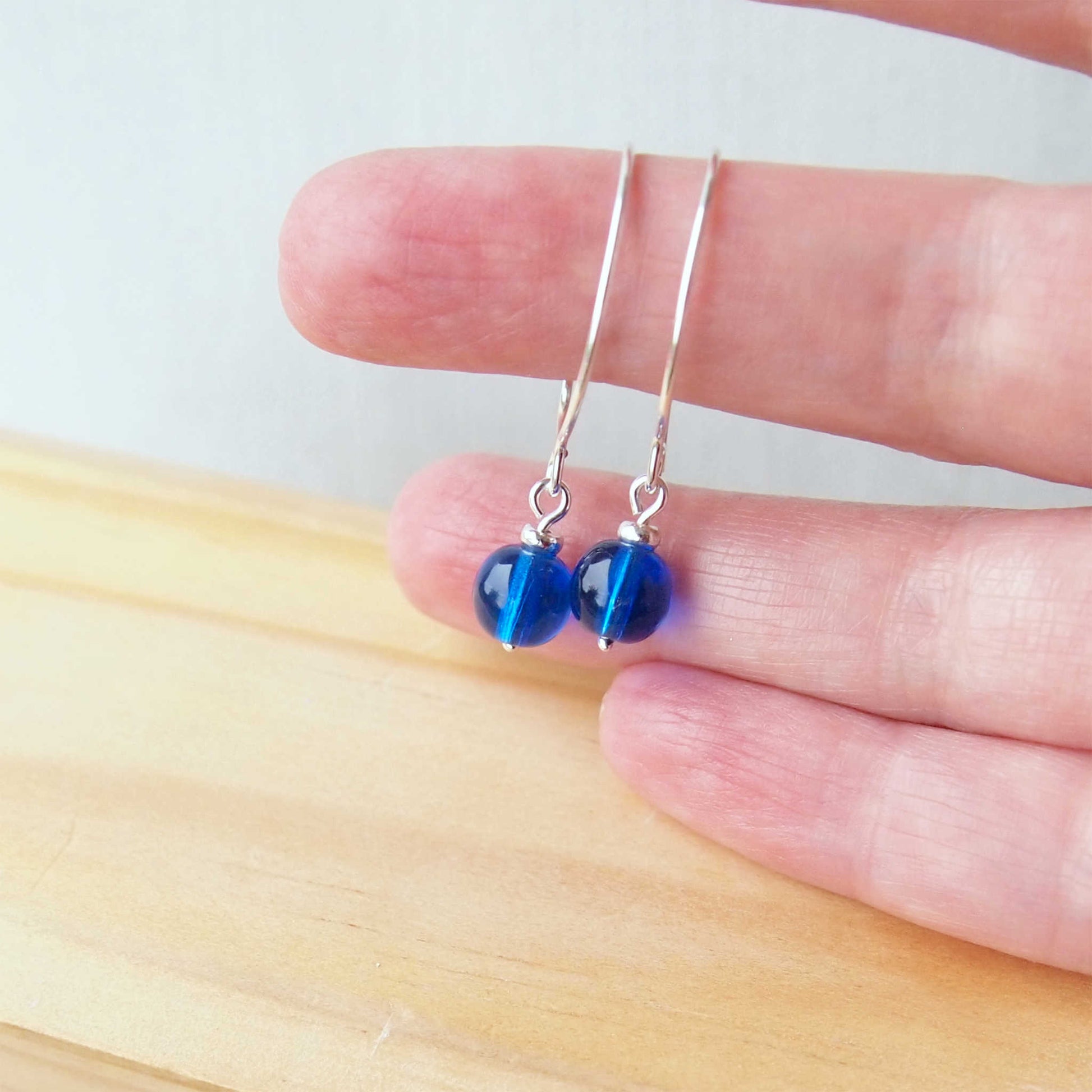 Cobalt blue Silver minimalist handmade silver hoops. Handcrafted ear wires with a round glass bead dropper. Made in Scotland by maram jewellery