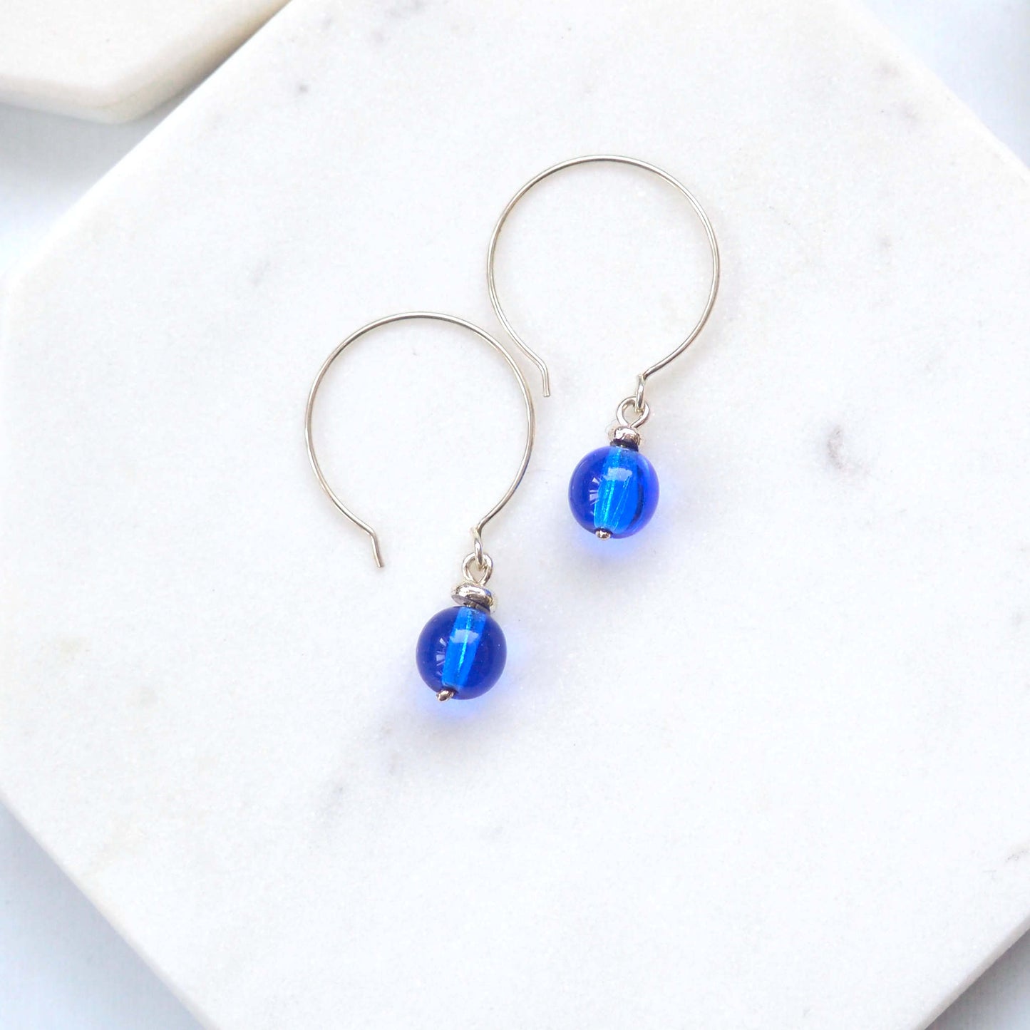 Cobalt blue Silver minimalist handmade silver hoops. Handcrafted ear wires with a round glass bead dropper. Made in Scotland by maram jewellery