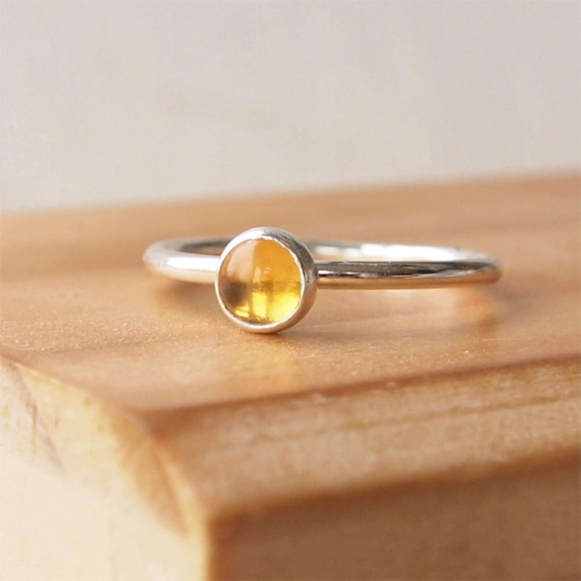 Citrine and Sterling Silver Ring made from a 5mm round warm yellow citrine gemstone set simply onto a modern band of round wire. Handmade to your ring size by maram jewellery in Scotland
