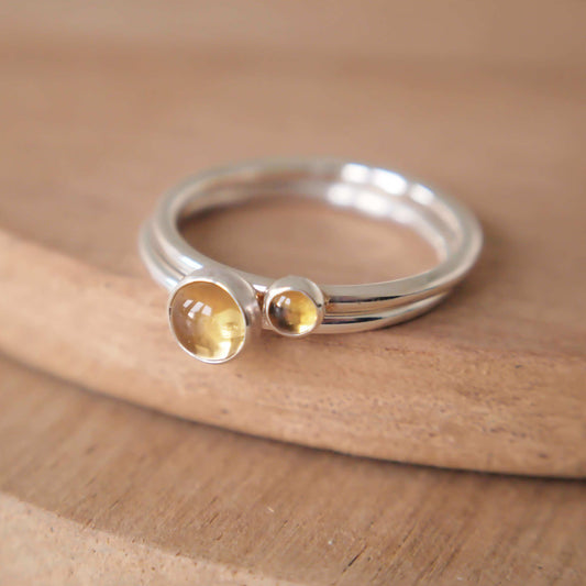 Two ring set in Sterling Silver and Citrine. The rings have two round cabochons in 5mm and 3mm size in a warm yellow colour, and are set very simply onto bands of Sterling Silver. Handmade in Scotland by Maram Jewellery