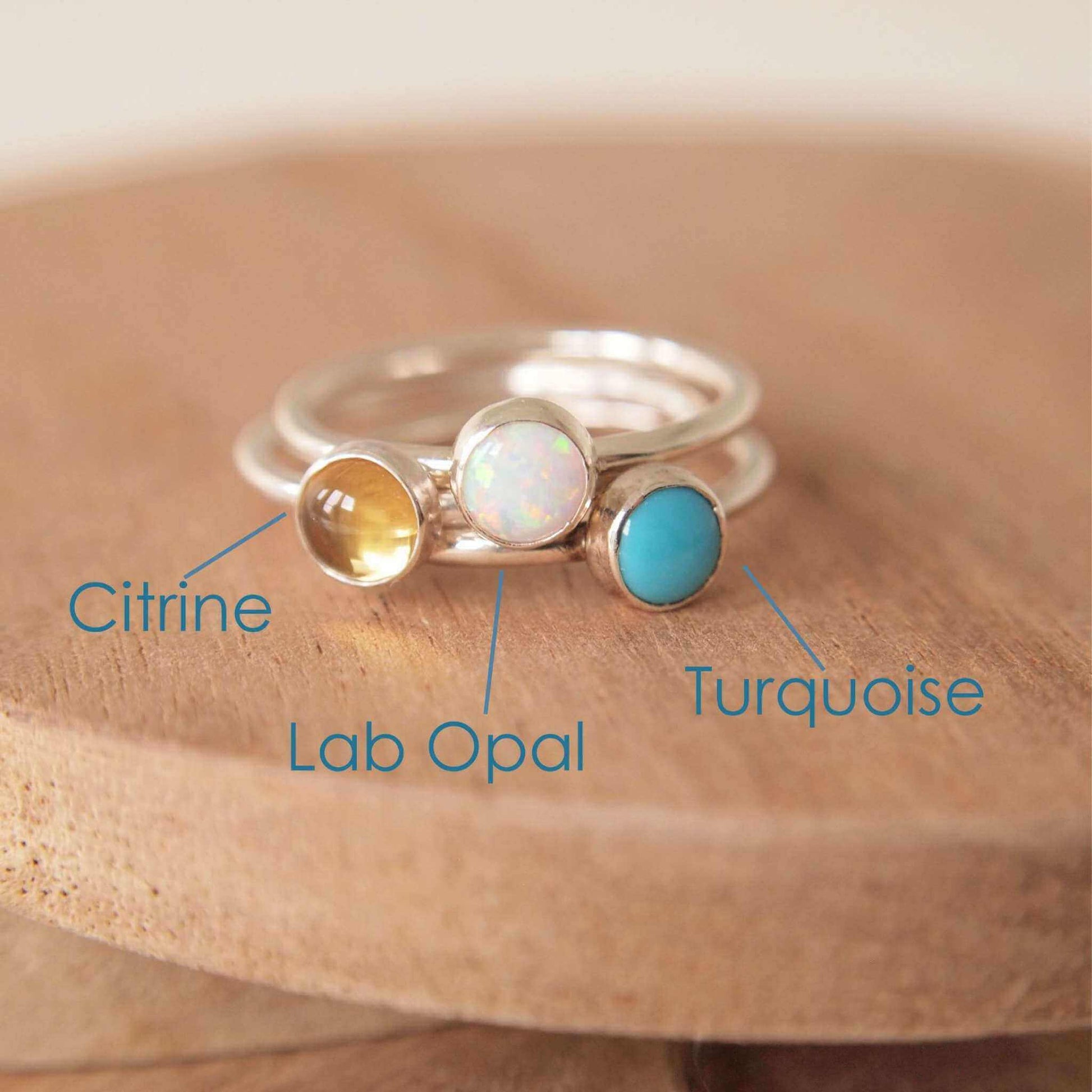 Three Silver rings, each set simply with a single gemstone in Lab Opal, Citrine and Turquoise in a round 3mm size. Birthstones for October, November and December. Handmade by Maram Jewellery in Edinburgh