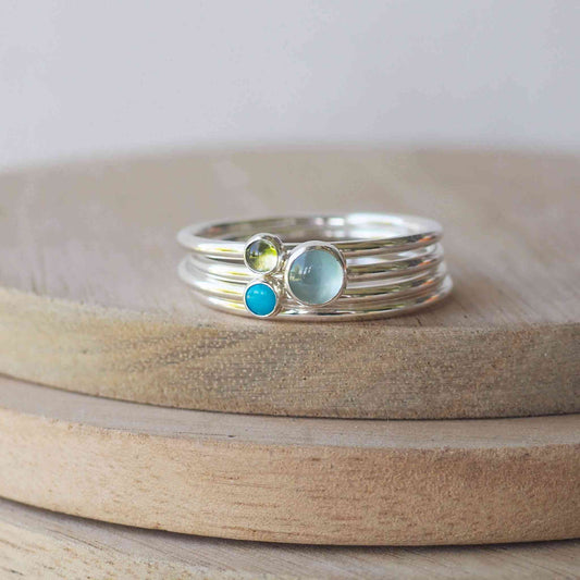 Three ring birthstone ring set made from sterling silver and three gemstones. This set has Cloudy Aquamarine, Peridot and Turquoise to mark March, August and Turquoise Birthstones.  Handmade in Scotland by Maram Jewellery