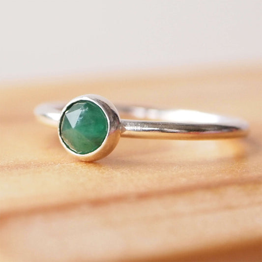 Simple Silver and Emerald ring with a round 5mm green emerald, May's Birthstone. Handmade by Maram Jewellery in Scotland