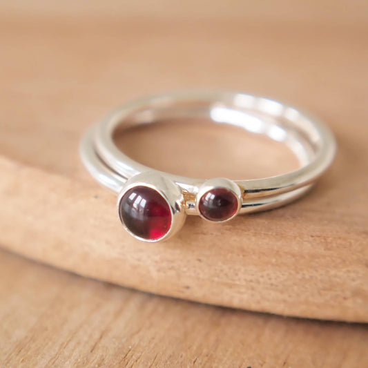 Double Birthstone ring set made from Sterling Silver and Garnet Cabochons. The rings are very simple in style and are in two sizes of stone 3mm and 5mm. Handmade by Maram Jewellery in Scotland