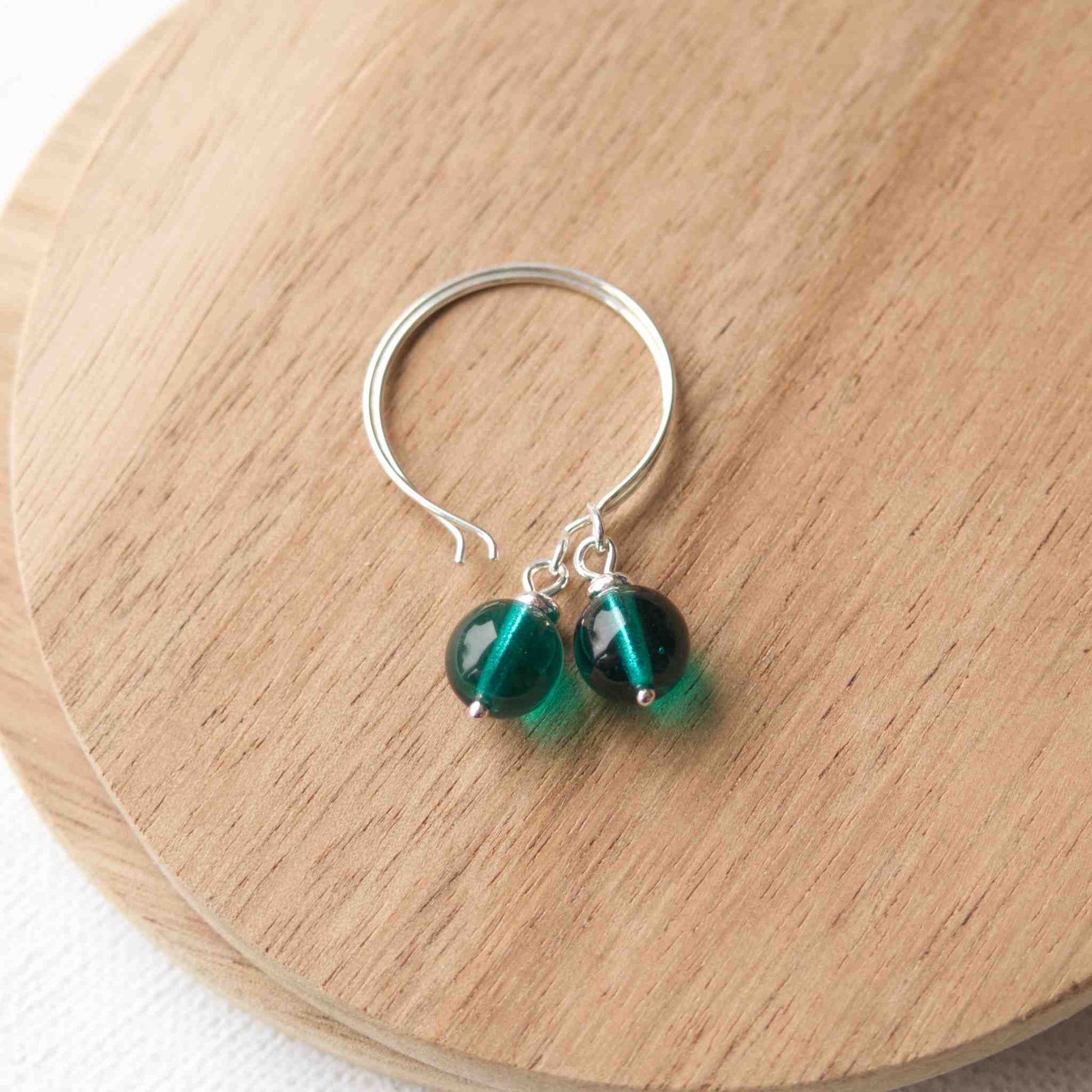 Green Silver minimalist handmade silver hoops. Handcrafted ear wires with a round glass bead dropper. Made in Scotland by maram jewellery