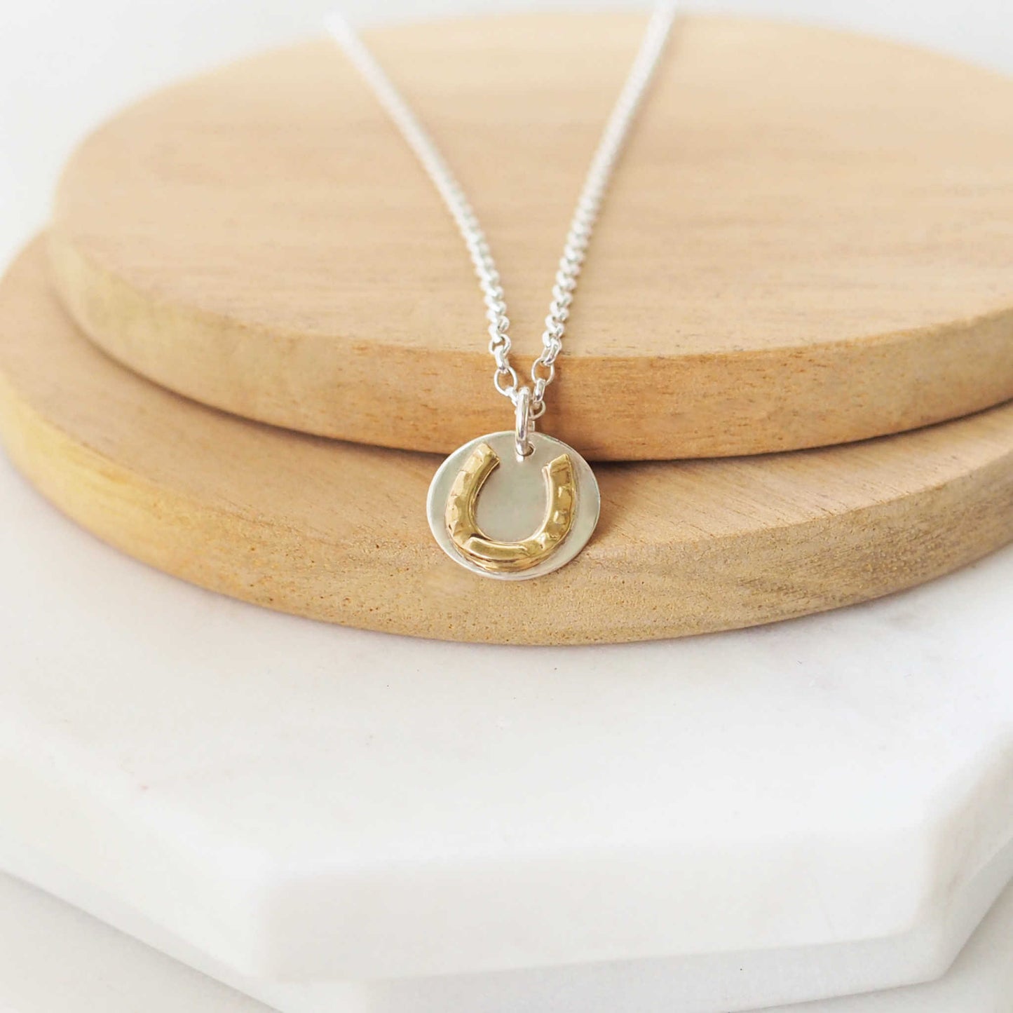 Coin disc charm necklace in Sterling Silver with a gold horseshoe design. A gift for love and luck. Made from Sterling SIlver and brass, handmade in Edinburgh UK by maram jewellery