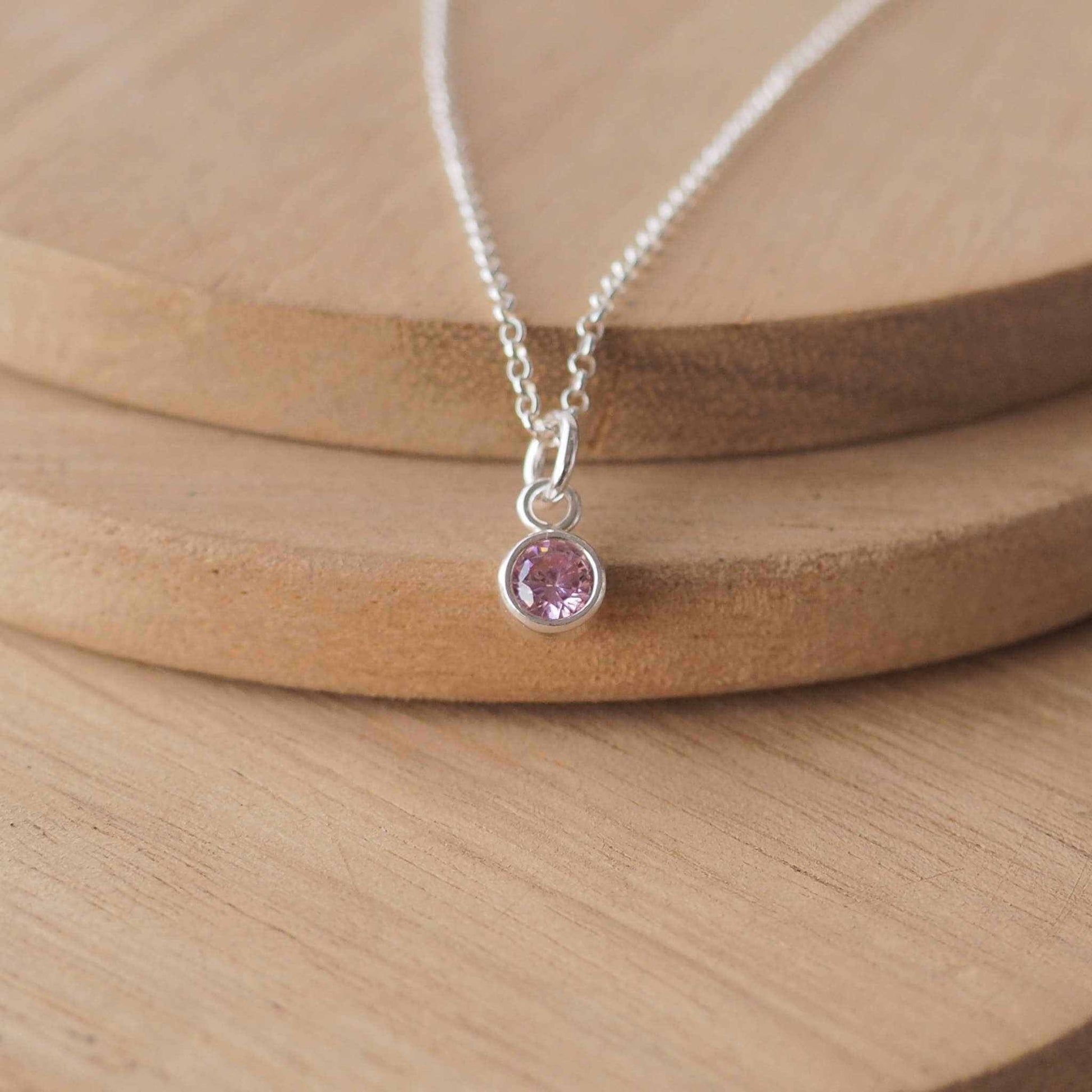 Small Sterling Silver and Cubic Zirconia Pink necklace. A small 4mm facet round pale pink gemstone with a simple silver setting on a trace style chain, suitable as a June Birthstone charm . Handmade in Scotland by Maram Jewellery