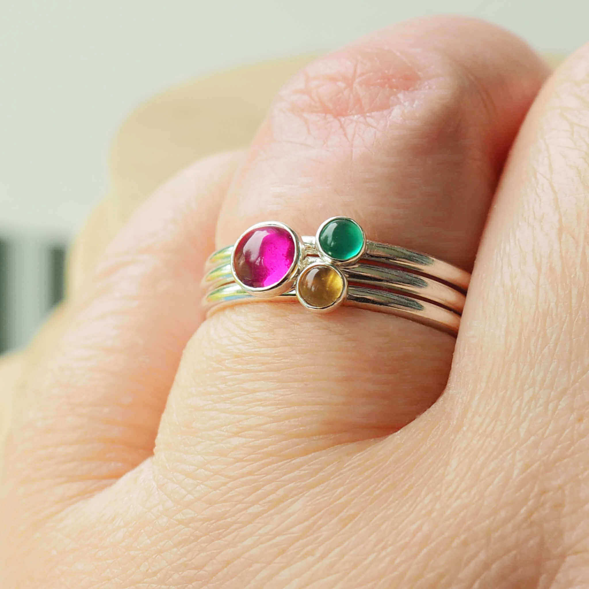 Three Birthstone Ring set made from Sterling Silver, each with a different birthstone in 5mm and 3mm size. This set has a large 5mm round Lab Ruby with a smaller 3mm Citrine and Green Agate. Birthstones for July, May and November. Handmade in Scotland by Maram Jewellery.