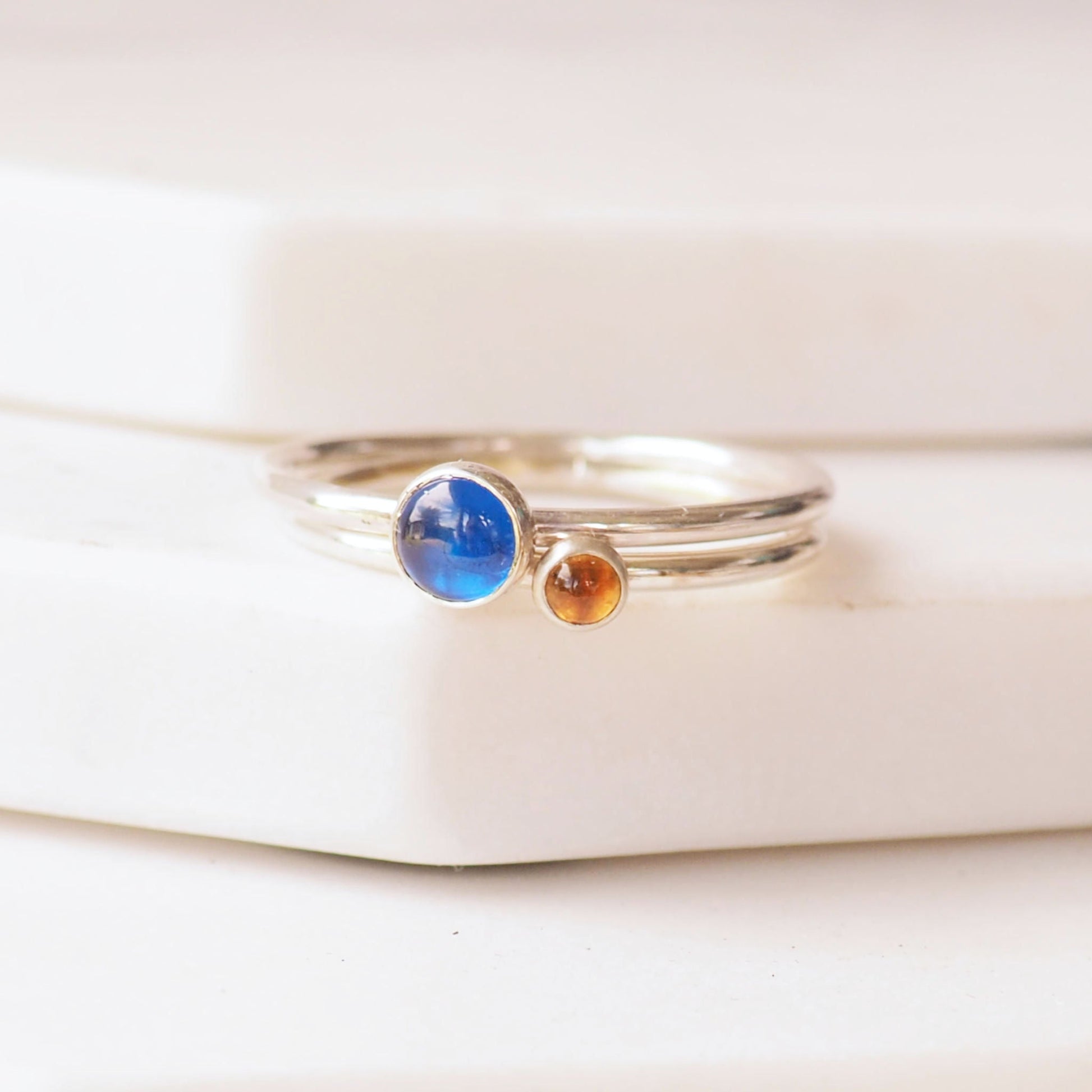 Two ring birthstone ring set with a Lab Sapphire and citrine - birthstones for September and November. Handmade with your choice of birthstones by maram jewellery in Edinburgh UK