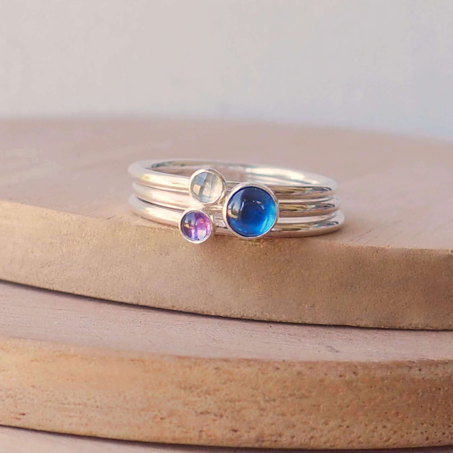 Three Birthstone Ring set made from Sterling Silver, each with a different birthstone in 5mm and 3mm size. This set has a large 5mm round Lab Sapphire with a smaller 3mm Amethyst and Blue Topaz. Birthstones for September, February and March. Handmade in Scotland by Maram Jewellery