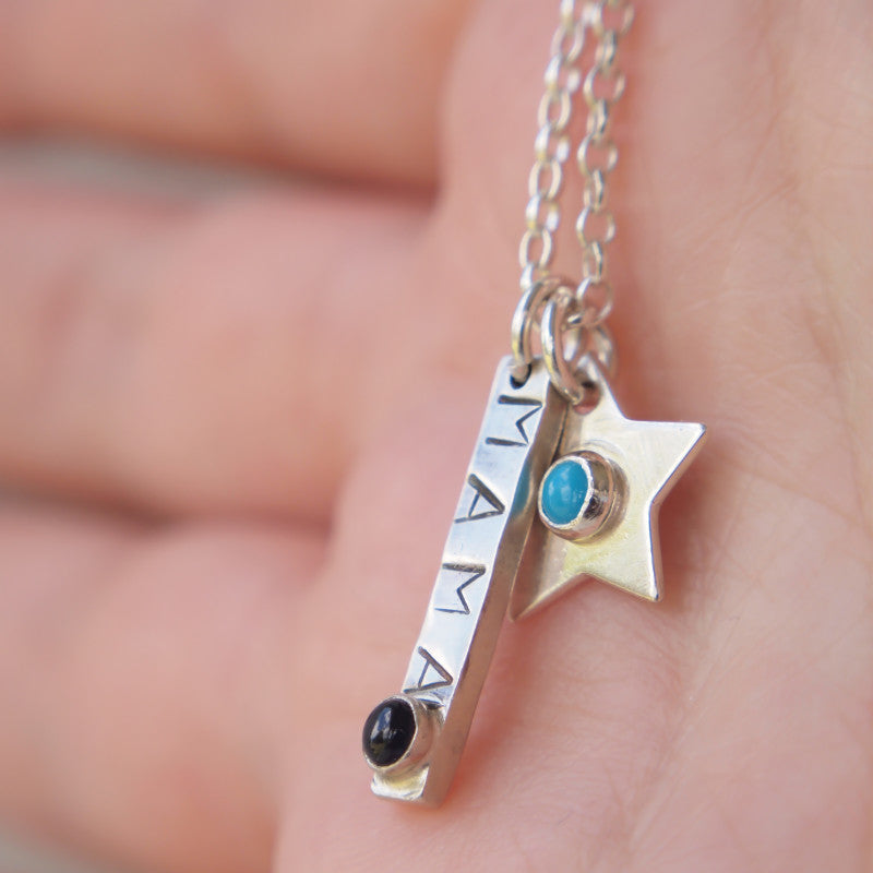Silver necklace with bar stamped 'mama' and birthstone with additional star pendants with birthstone centres