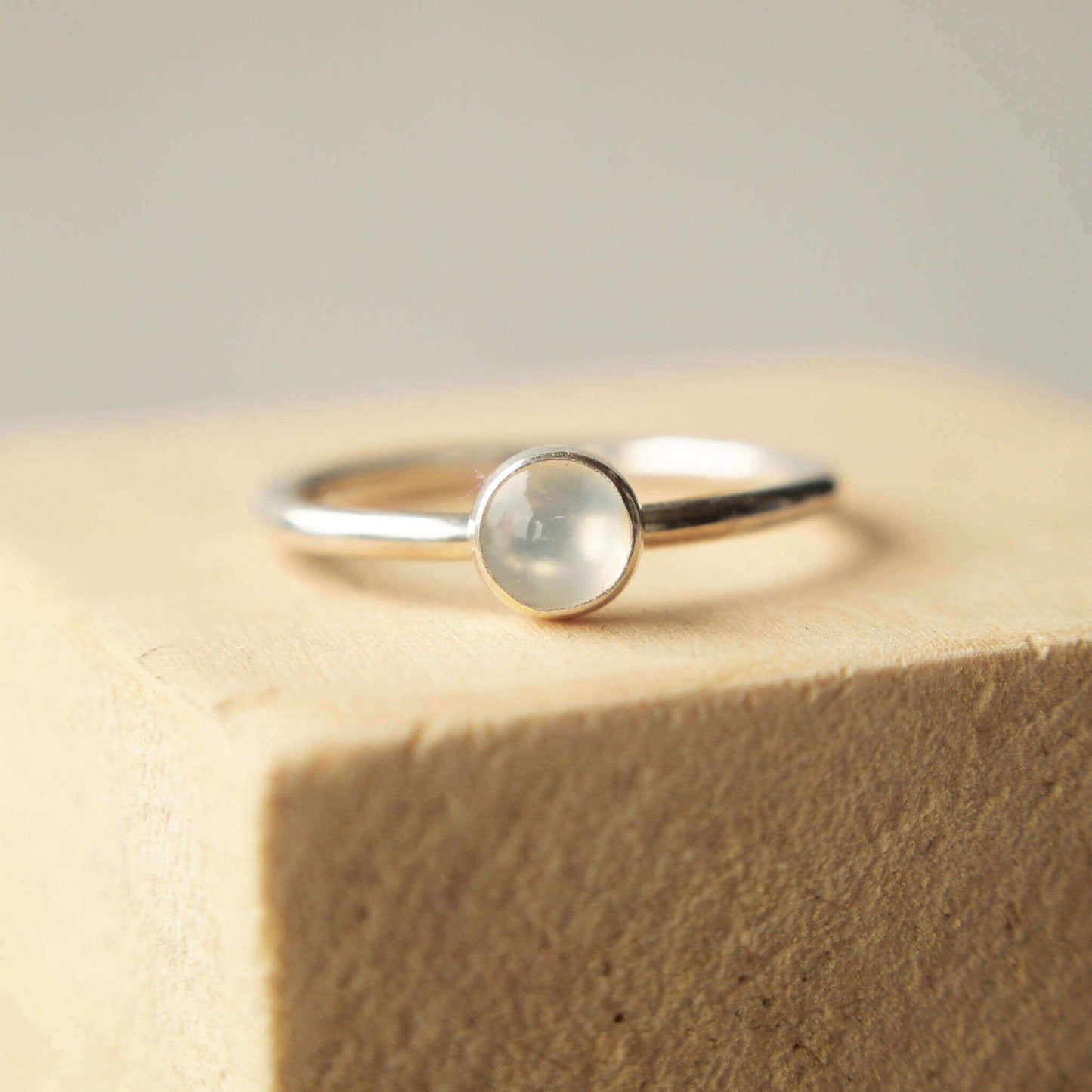 Sterling silver and moonstone cabochon ring. 5 mm sized milky white cabochon stone on a fully round band of sterling silver. Handmade in Scotland by maram jewellery