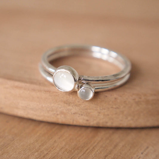 Moonstone double ring set with two sizes of stone. Rings are Sterling Silver with a round band and cabochon milky white gemstones in a 5mm and 3mm size. Handmade in Scotland by maram jewellery